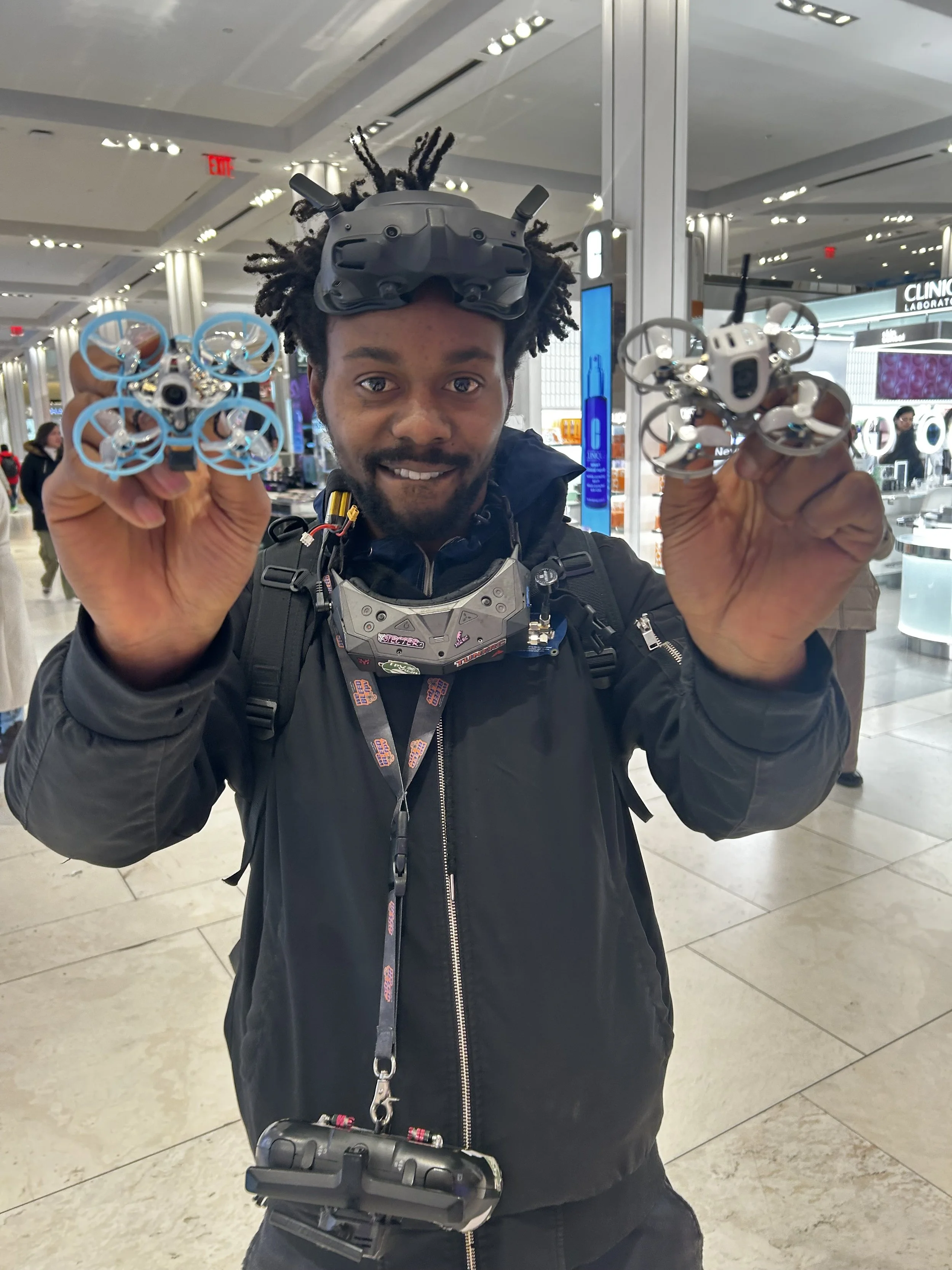 FPV Vegan holding two of his drones