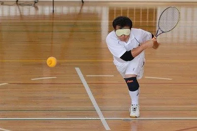 BLV Tennis inventor, Miyoshi Takei, hitting as forehand. Photo courtesy of Ayako Matsui