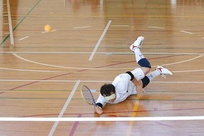 BLV Tennis inventor, Miyoshi Takei, diving for a forehand return. Photo courtesy of Ayako Matsui