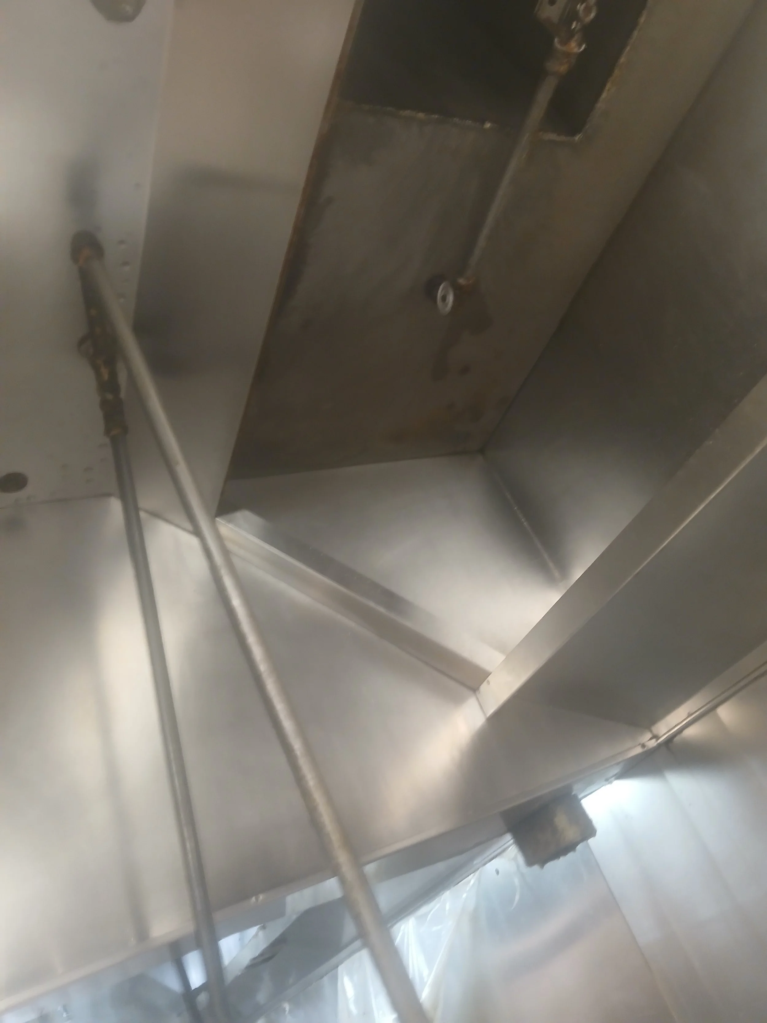 Close-up view of the inside of a stainless steel kitchen hood