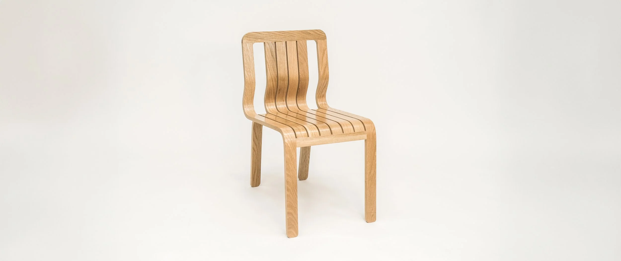 A wooden chair with a slatted backrest and seat, set against a plain white background.