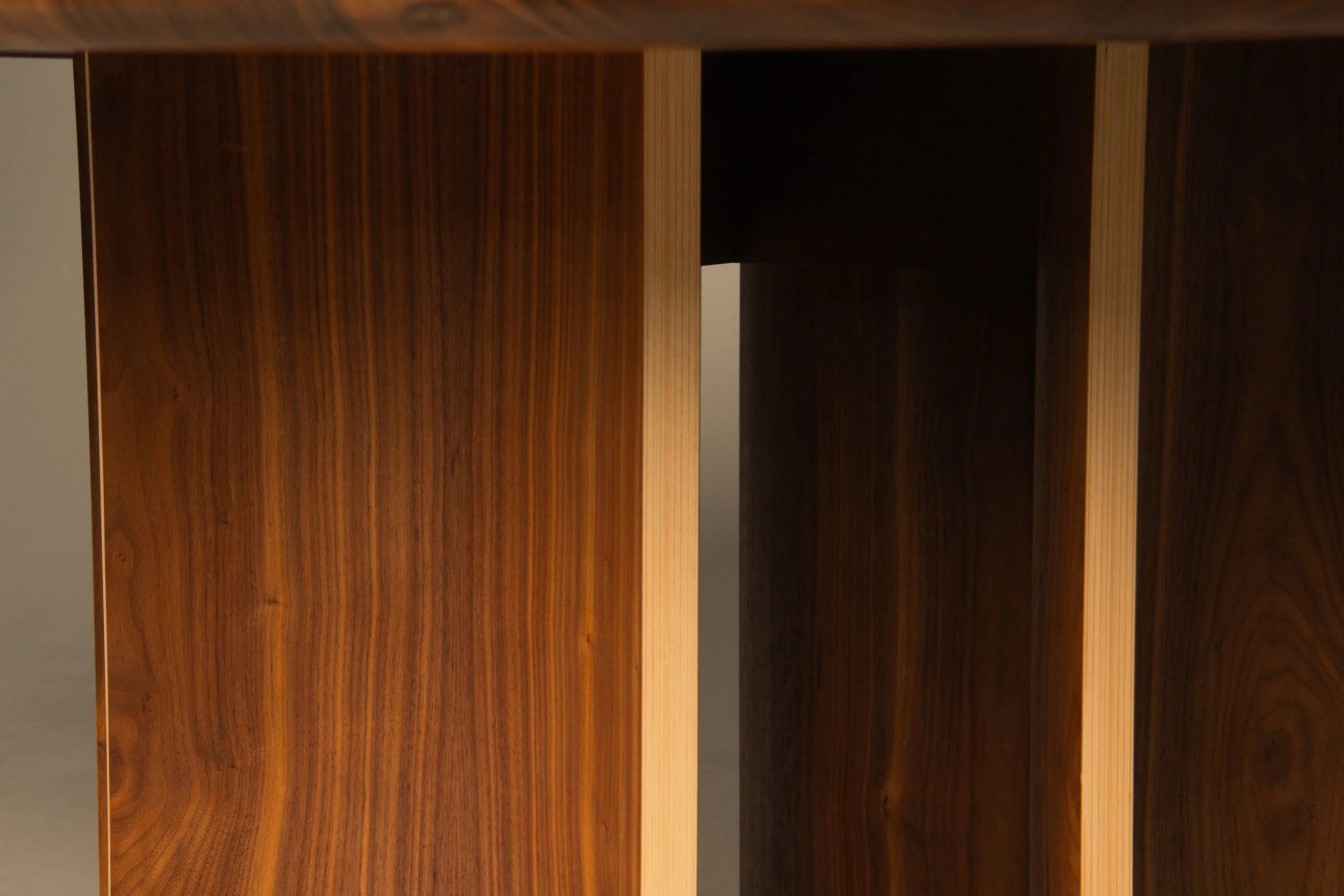 Close-up of wooden furniture showing two vertical panels with natural wood grain and a narrow gap between them.