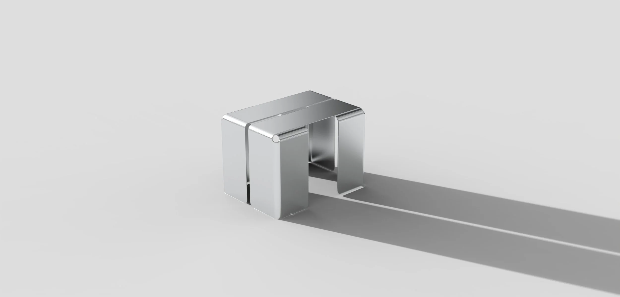 Silver modern desk lamp with a sleek, minimalist design casting a shadow on a light gray background.