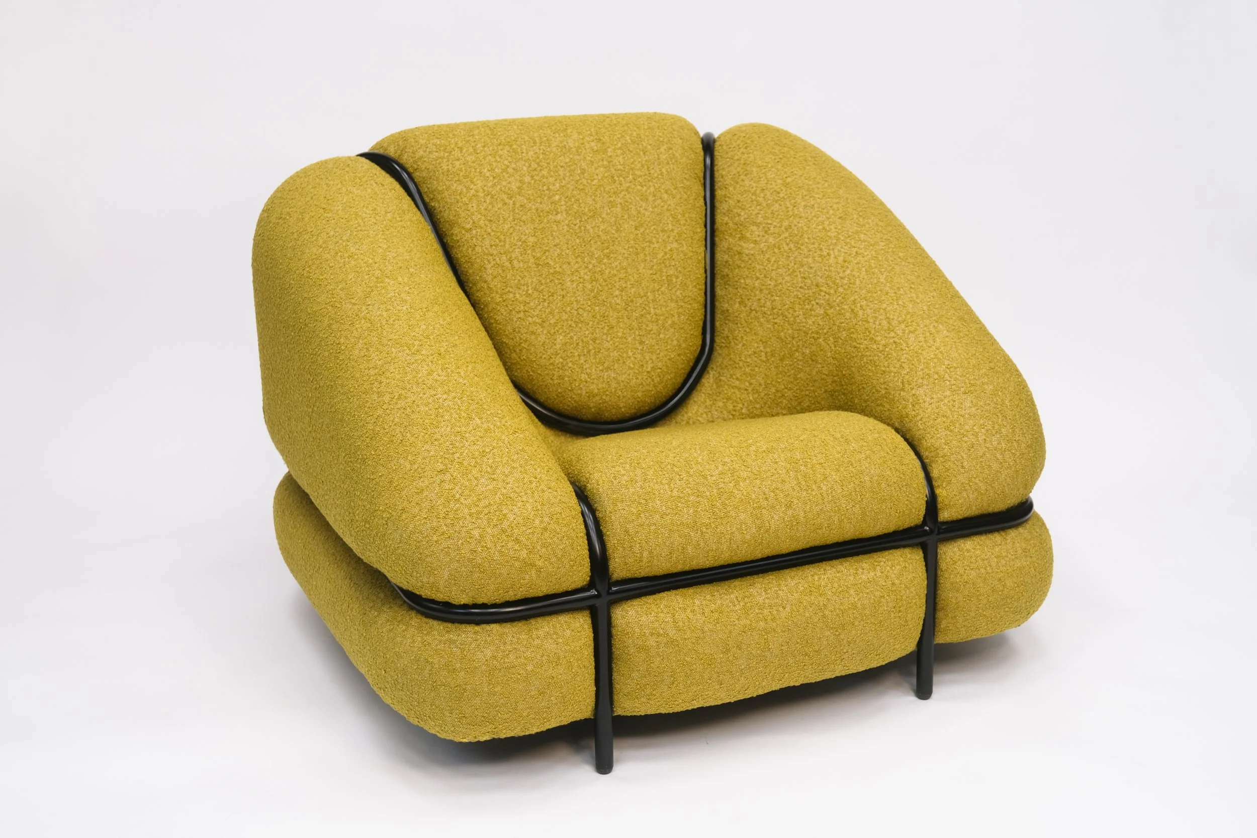 Yellow modern armchair with black metal frame on a white background.