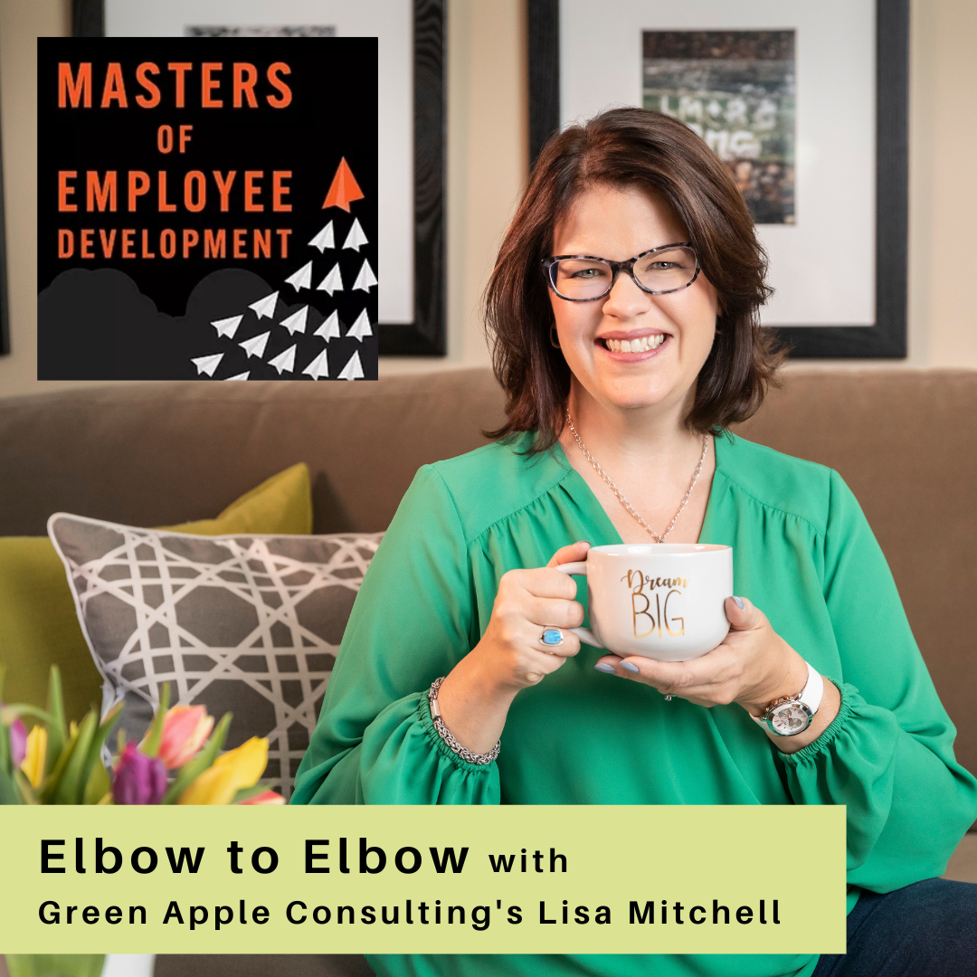 A woman with glasses sitting on a couch holding a white mug that says "Dream Big." She is smiling and wearing a green blouse. There is a pillow with a geometric pattern behind her and framed pictures on the wall. Inset in the top left corner is a logo for 'Masters of Employee Development' with stylized paper airplanes. At the bottom, there is a light green banner with black text that reads, 'Elbow to Elbow with Green Apple Consulting's Lisa Mitchell.'