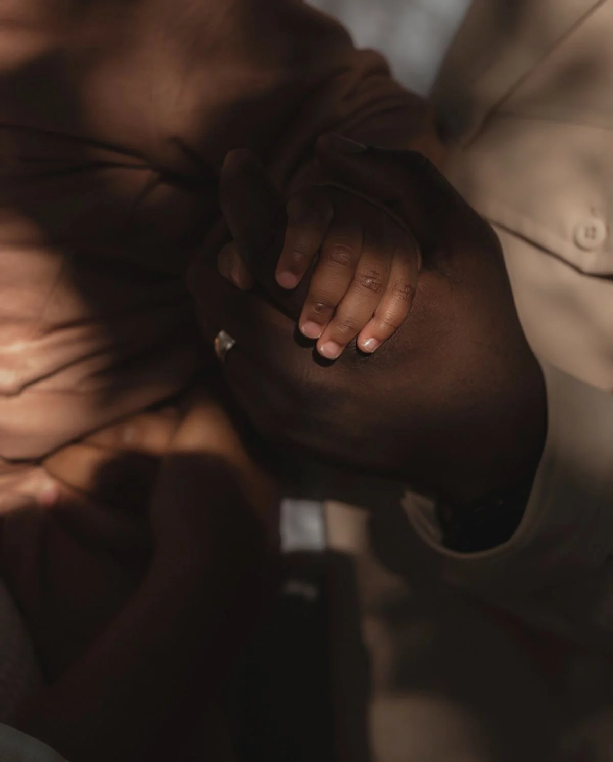 Two people sharing a kiss, one with hand on the other's face, in close-up shot.