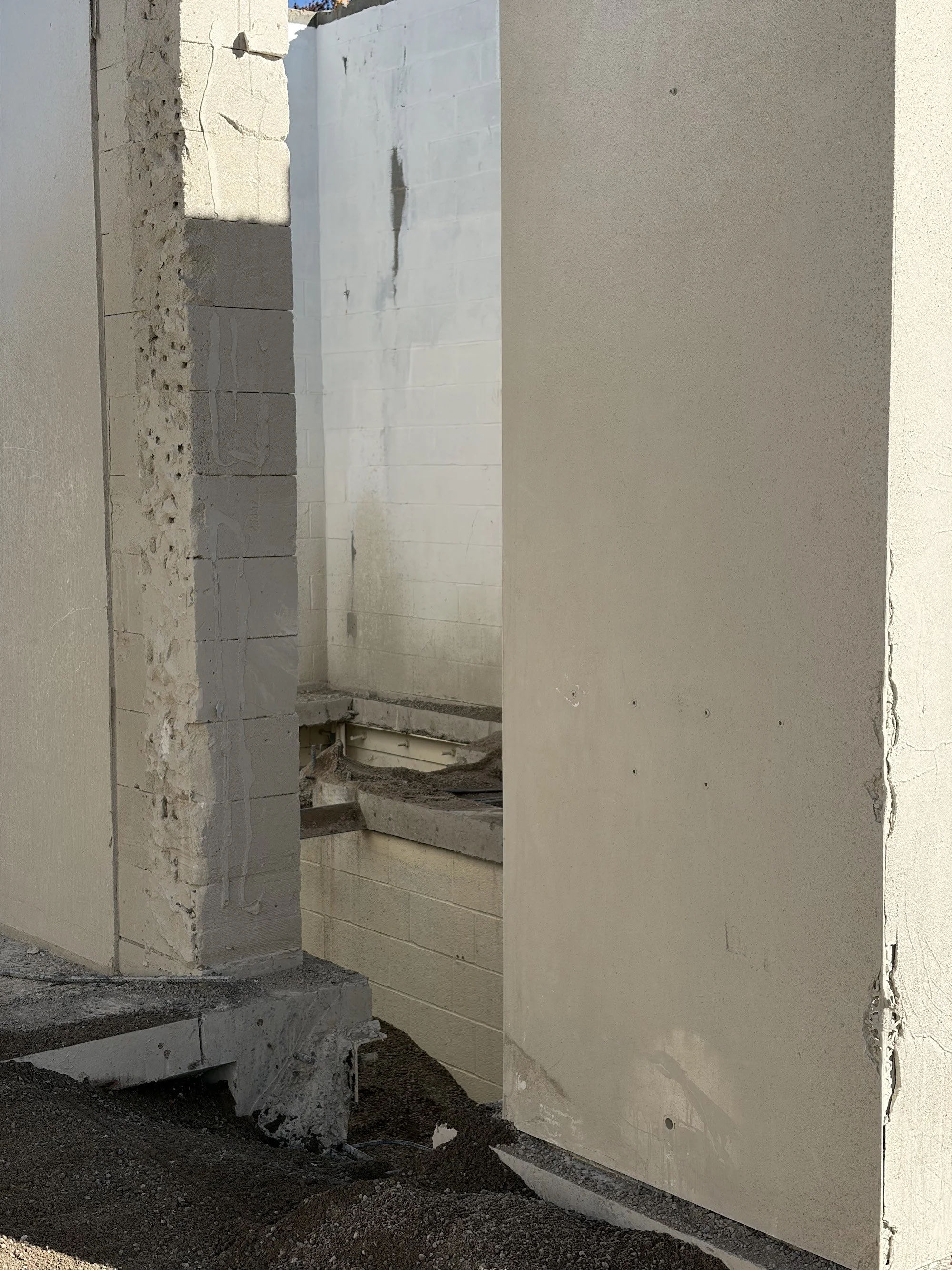 Partially dismantled interior walls with exposed masonry and floor openings.