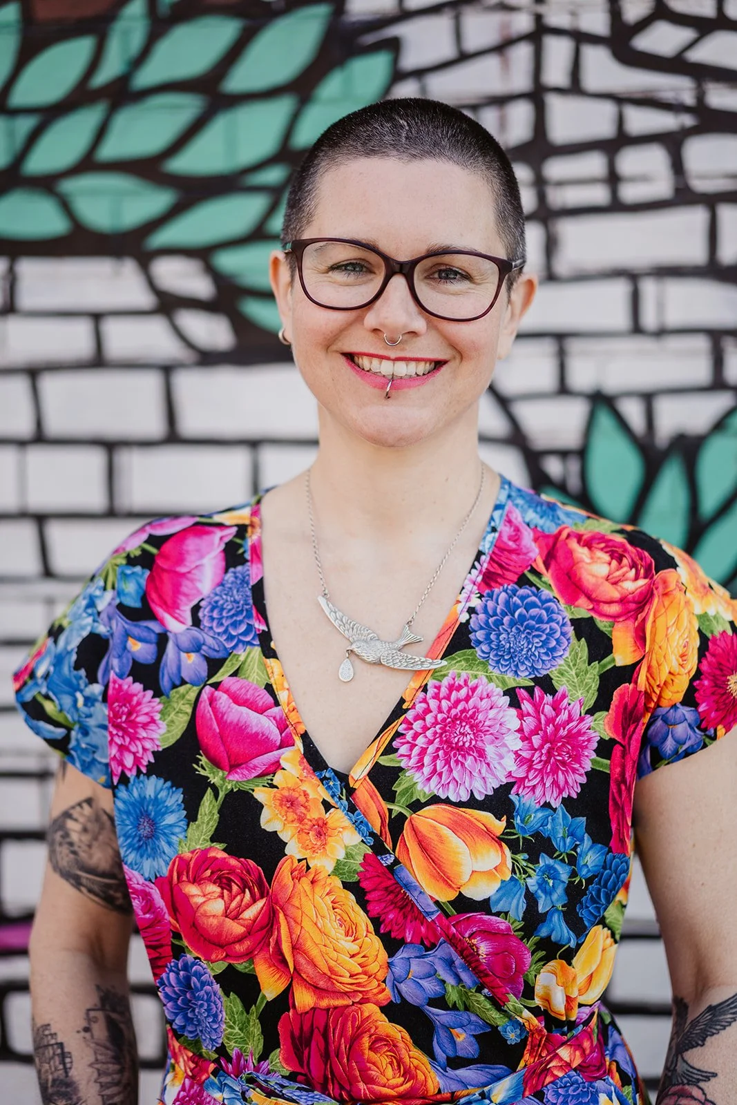 Bea Darling smiling wearing a bright jumpsuit