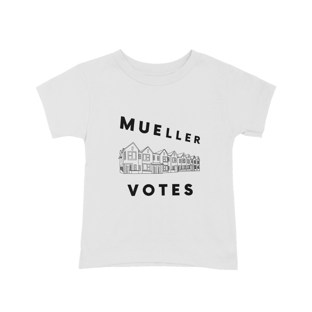 White children's T-shirt with black text saying 'Muller Votes' above and below a line drawing of a row of houses.