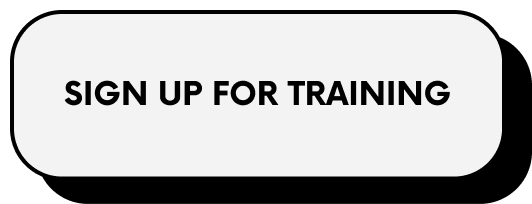 Sign with text 'Sign Up for Training' inside a black rounded rectangle.