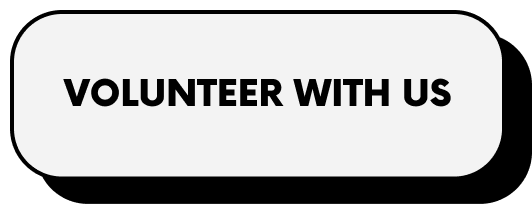 Black text on a white rounded rectangle background that reads 'Volunteer With Us'