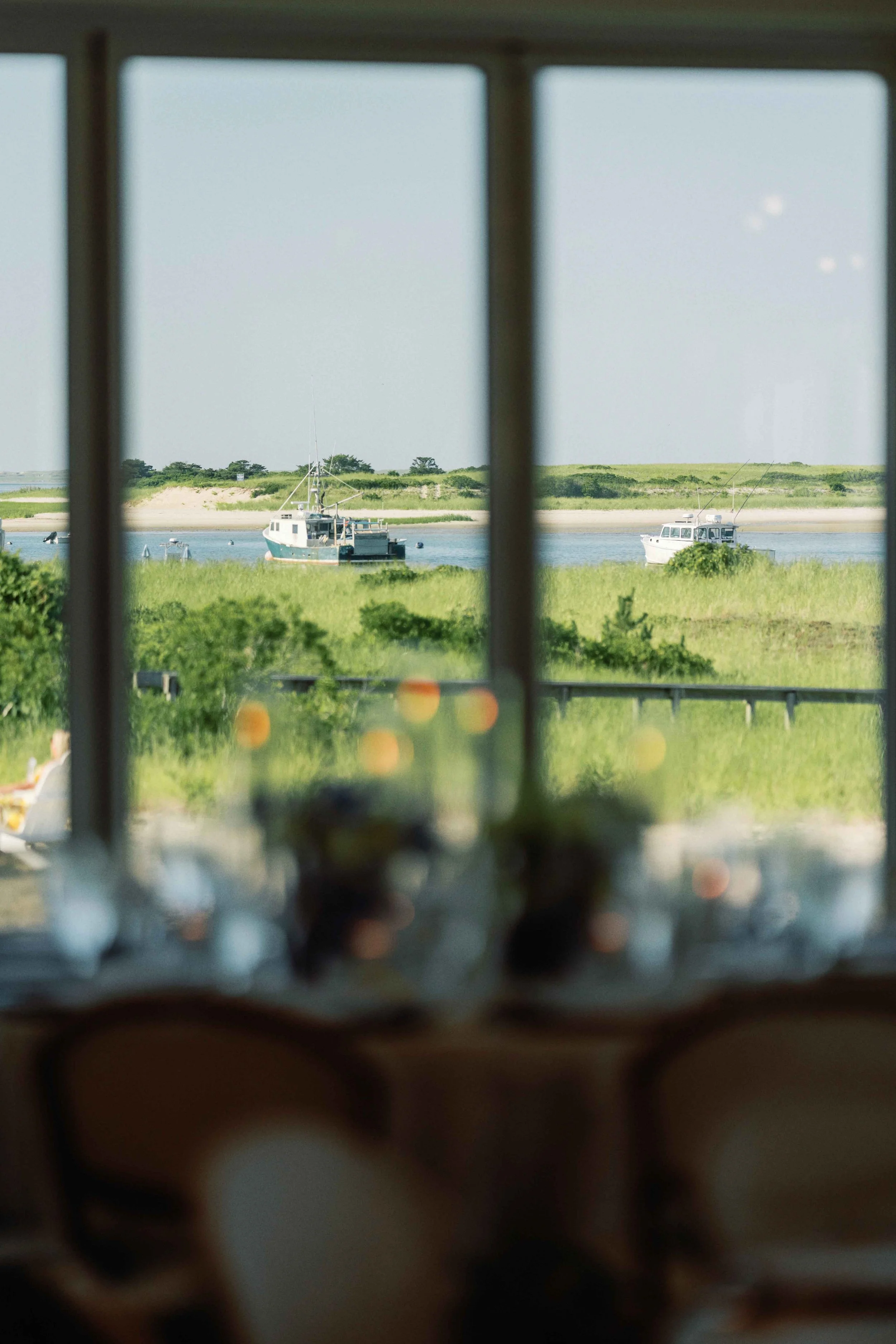 View from a reception table of the Massachusetts coastline featuring boats