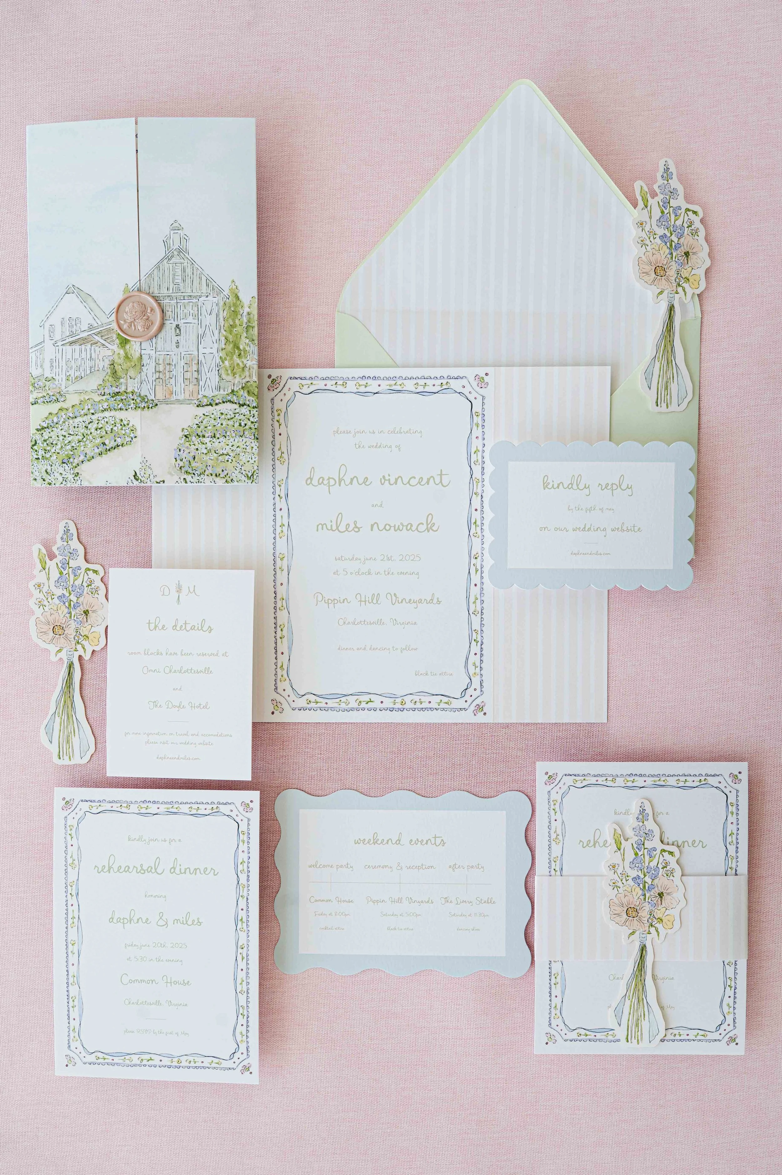 Wedding invitation suite with floral accents, RSVP card, and envelope on pink fabric background.