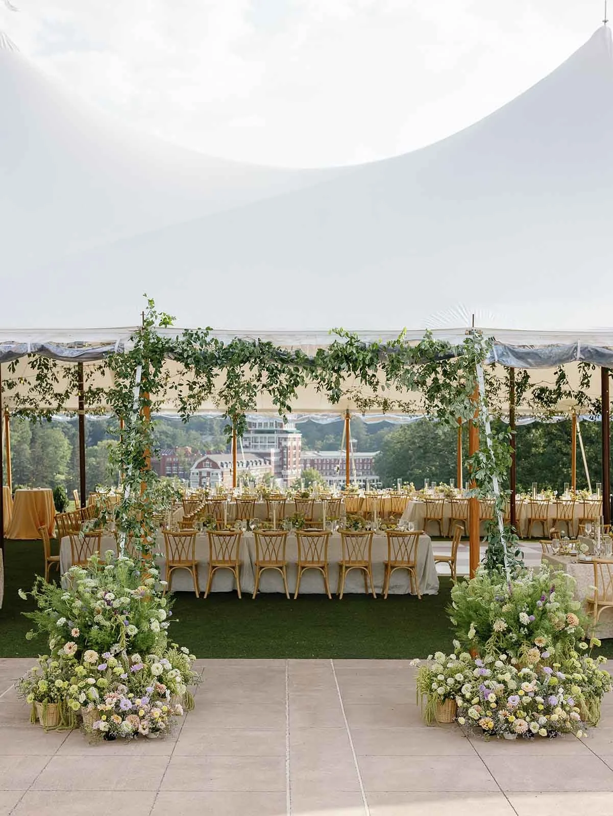 Hot Springs, Virginia outdoor tent wedding set-up with florals around the outside of the tent