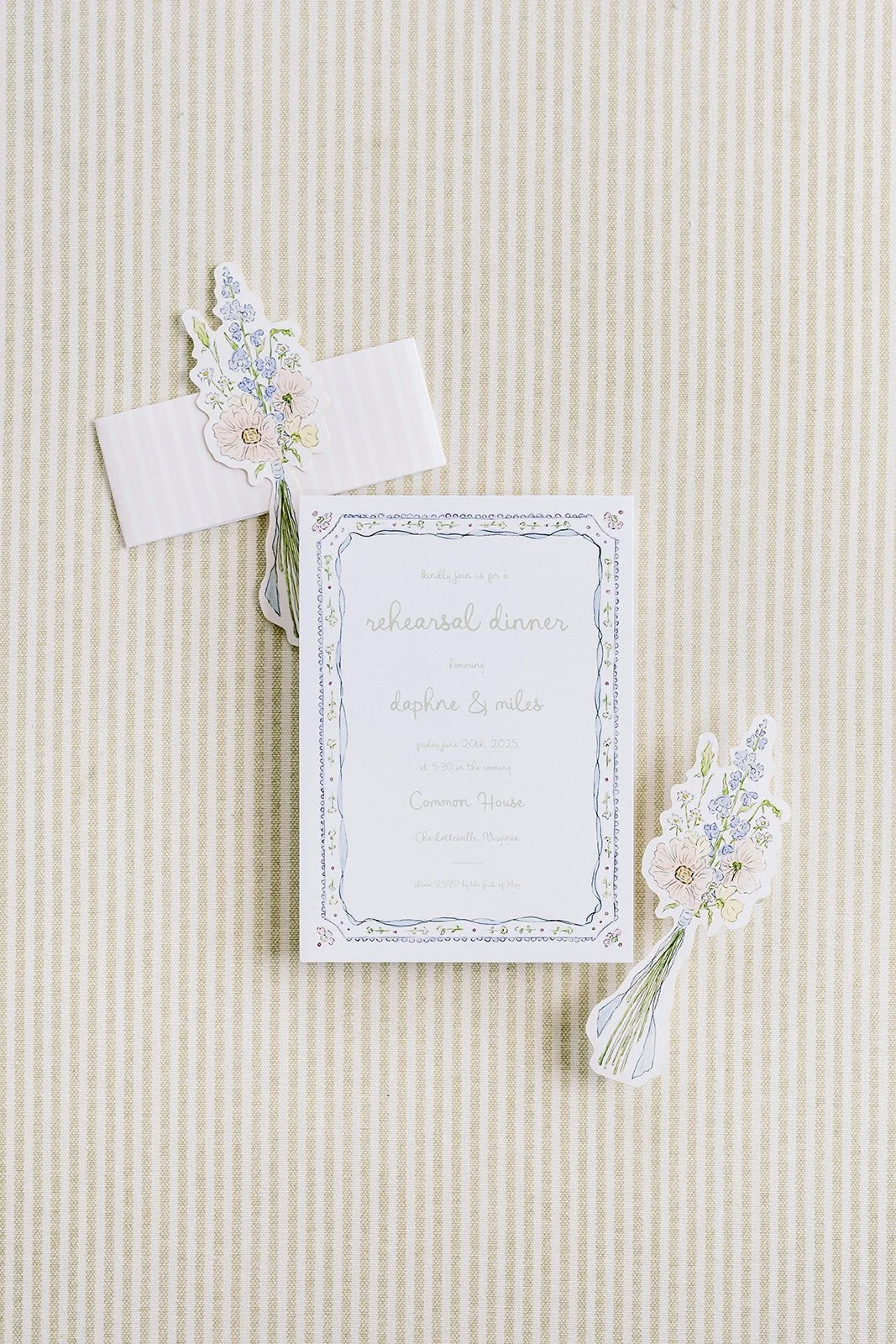 Floral wedding invitation suite created by a watercolor artist featuring the wedding invitation with two floral cutouts on a neutral background