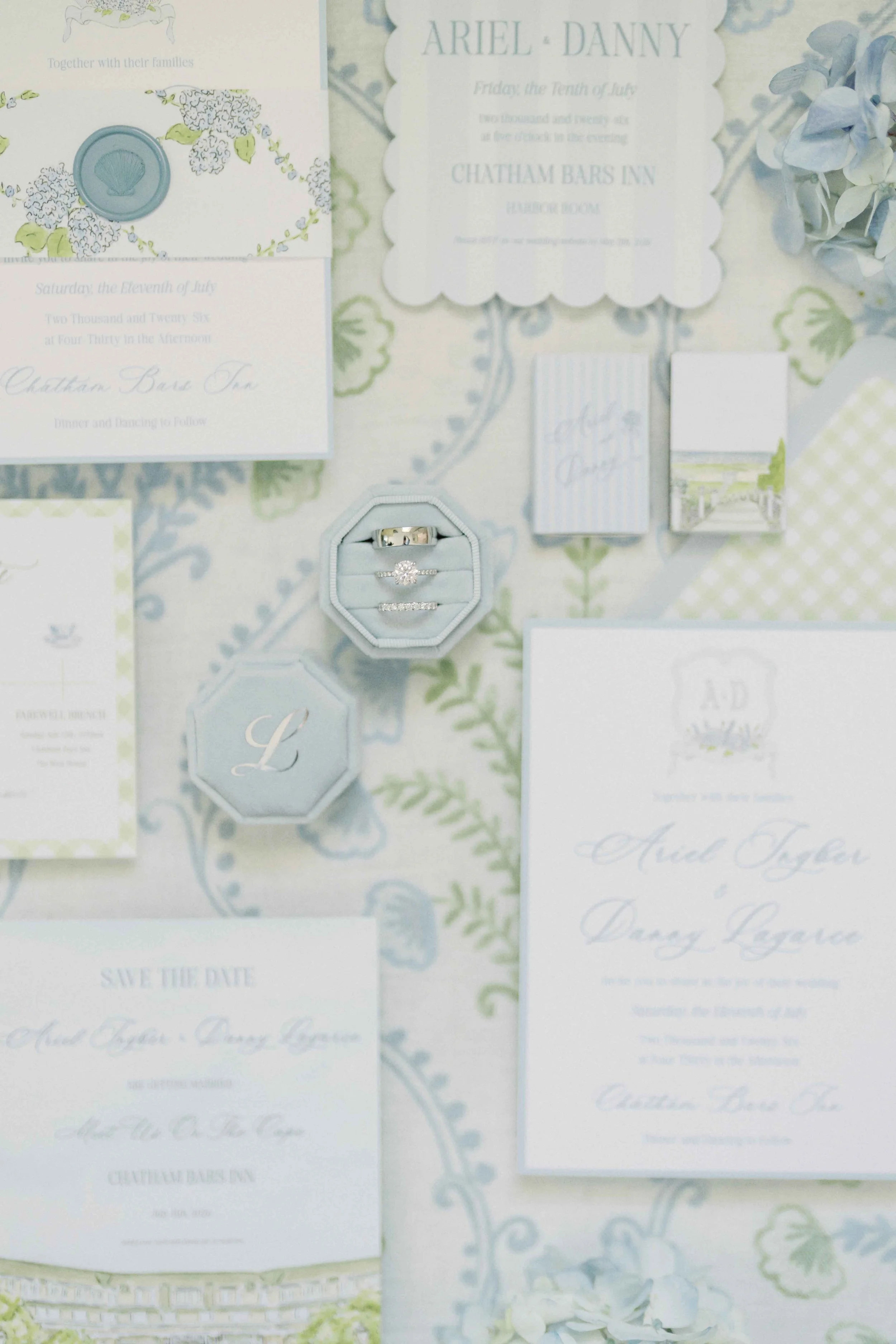 Coastal stationery suite set on top of a blue and green tablecloth