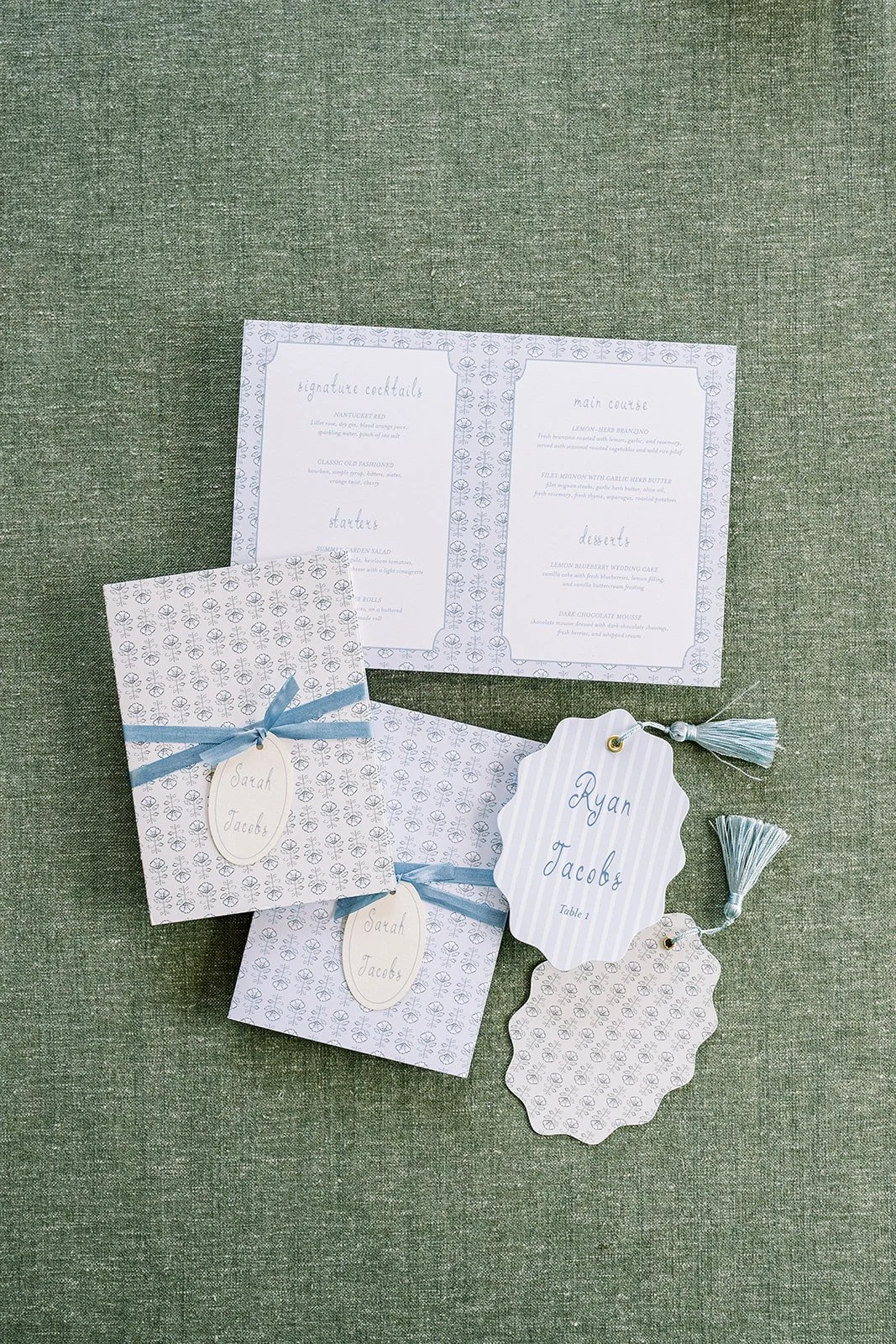 Nantucket-themed wedding stationery details featuring wedding menu, table numbers, and other hand-drawn watercolor illustrations