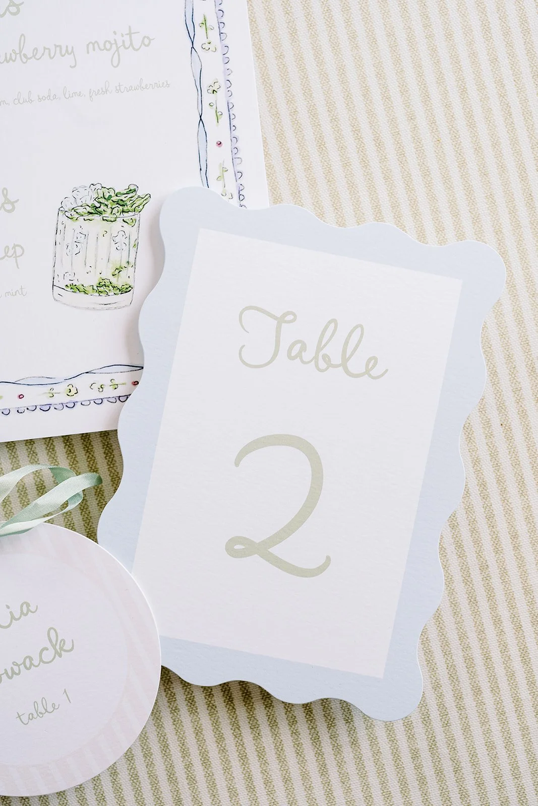 Floral wedding day-of paper created by a watercolor artist featuring a table number