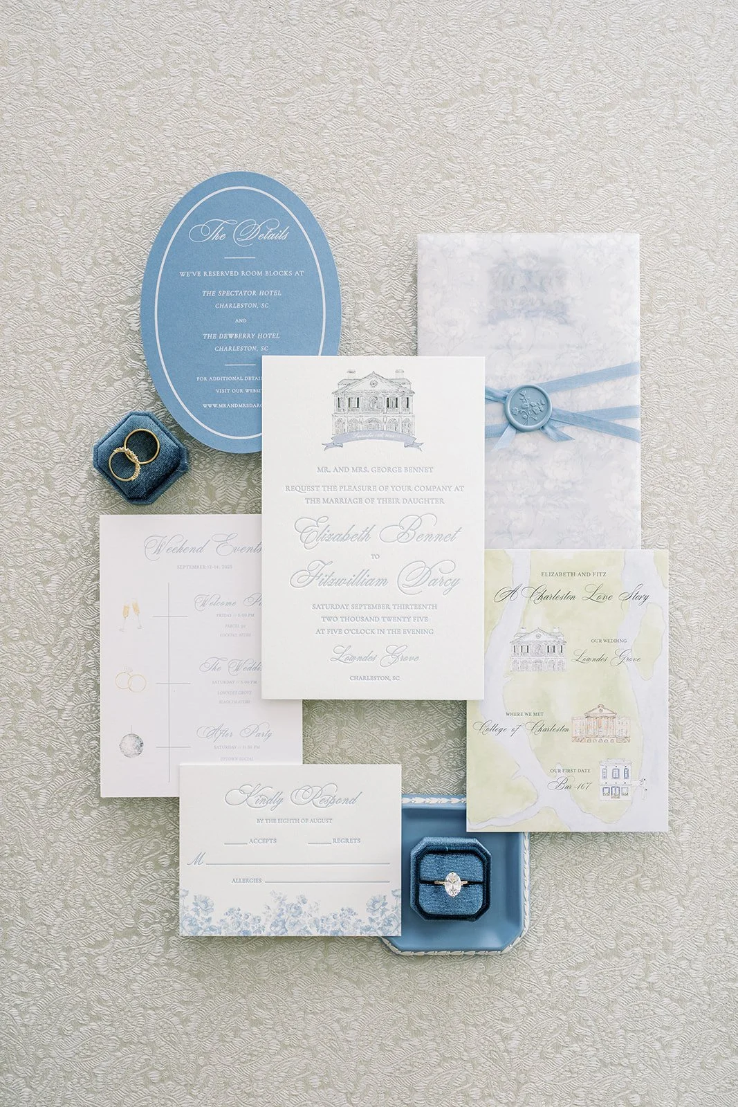 Blue and white elegant wedding invitation suite featuring florals and custom venue illustrations created by a watercolor artist