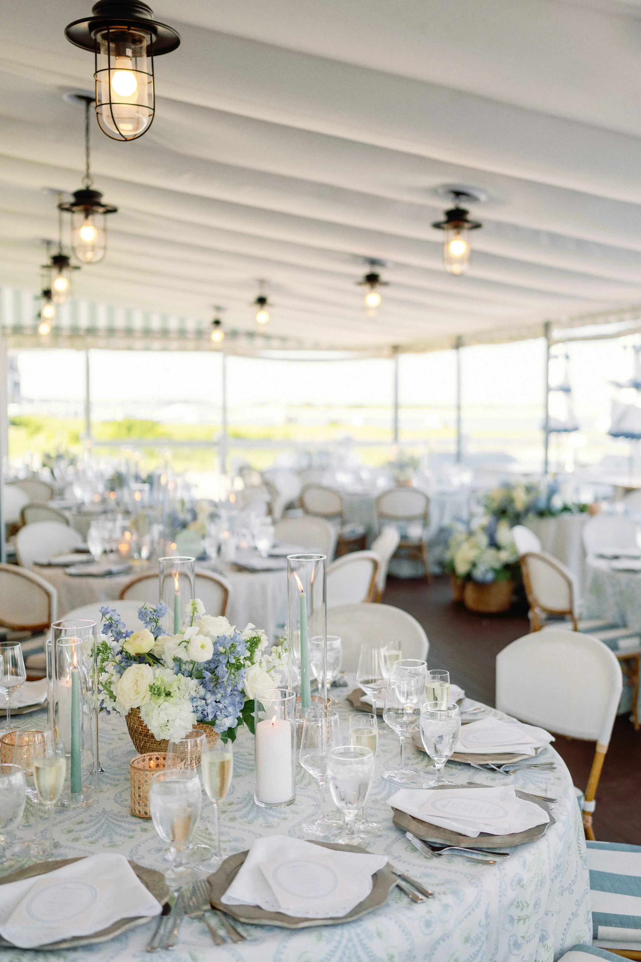 Elegant wedding reception with blue and green accents, featuring candles and florals