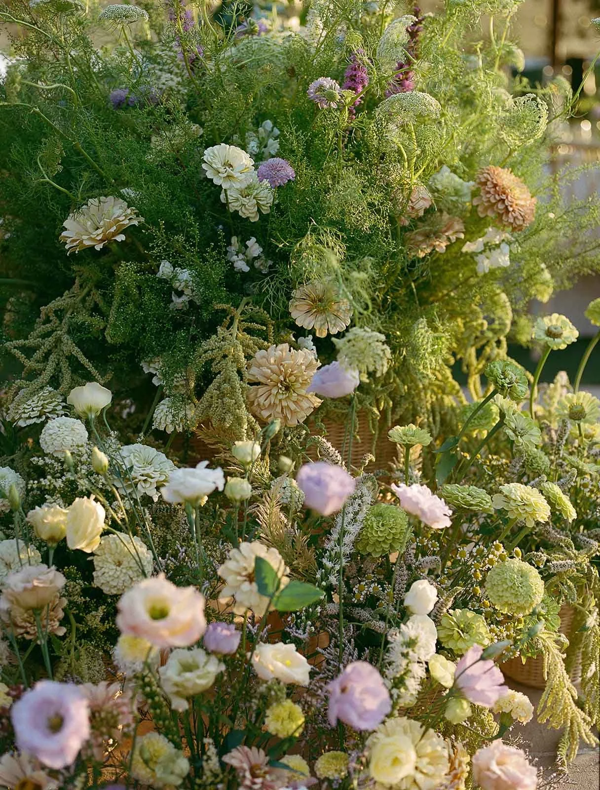 Luxury wedding florals featuring pops of yellow, purple, and pink with greenery