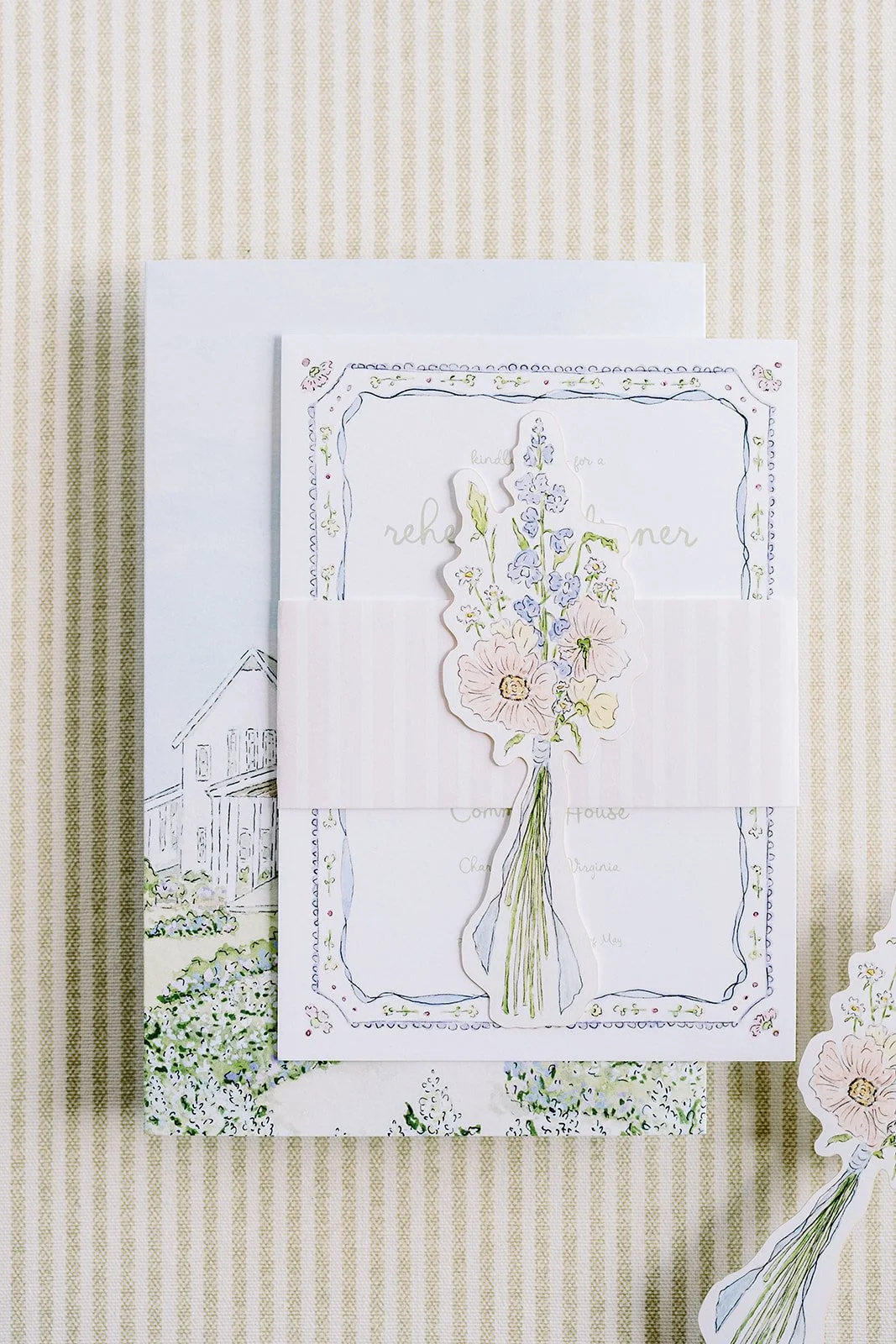 Floral wedding invitation suite created by a watercolor artist displaying floral cutouts and the invitation

