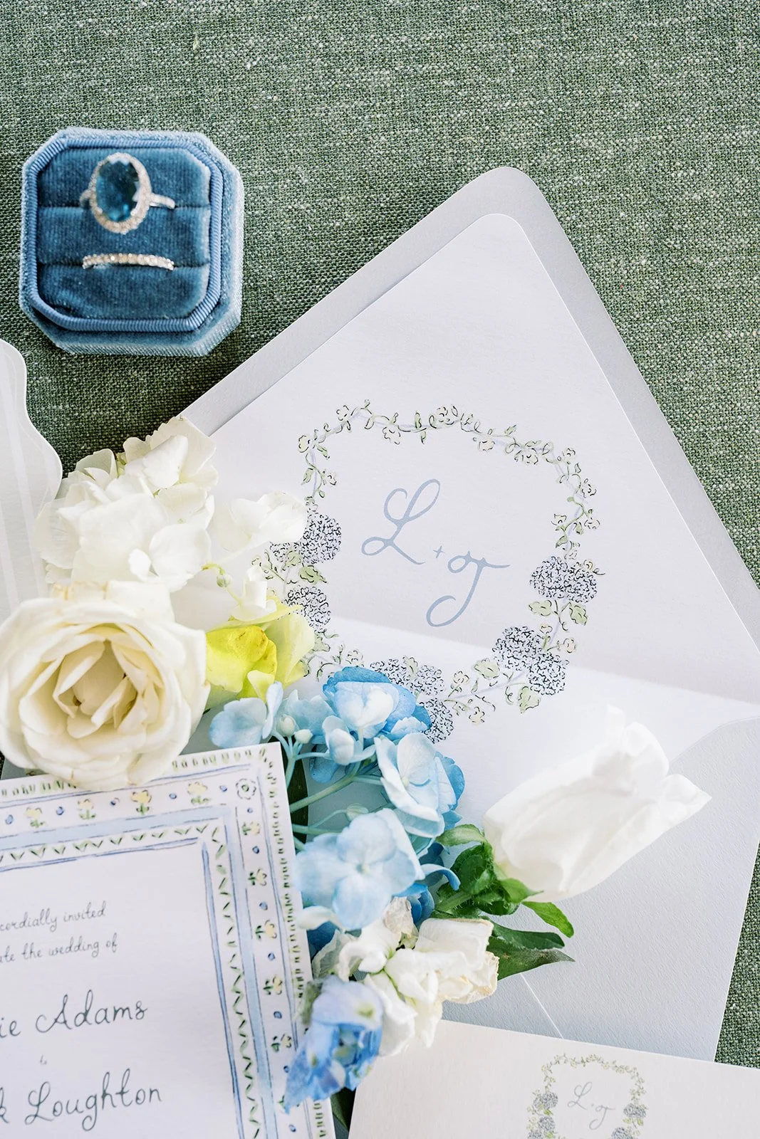 Nantucket-themed wedding stationery details featuring a custom floral monogram crest