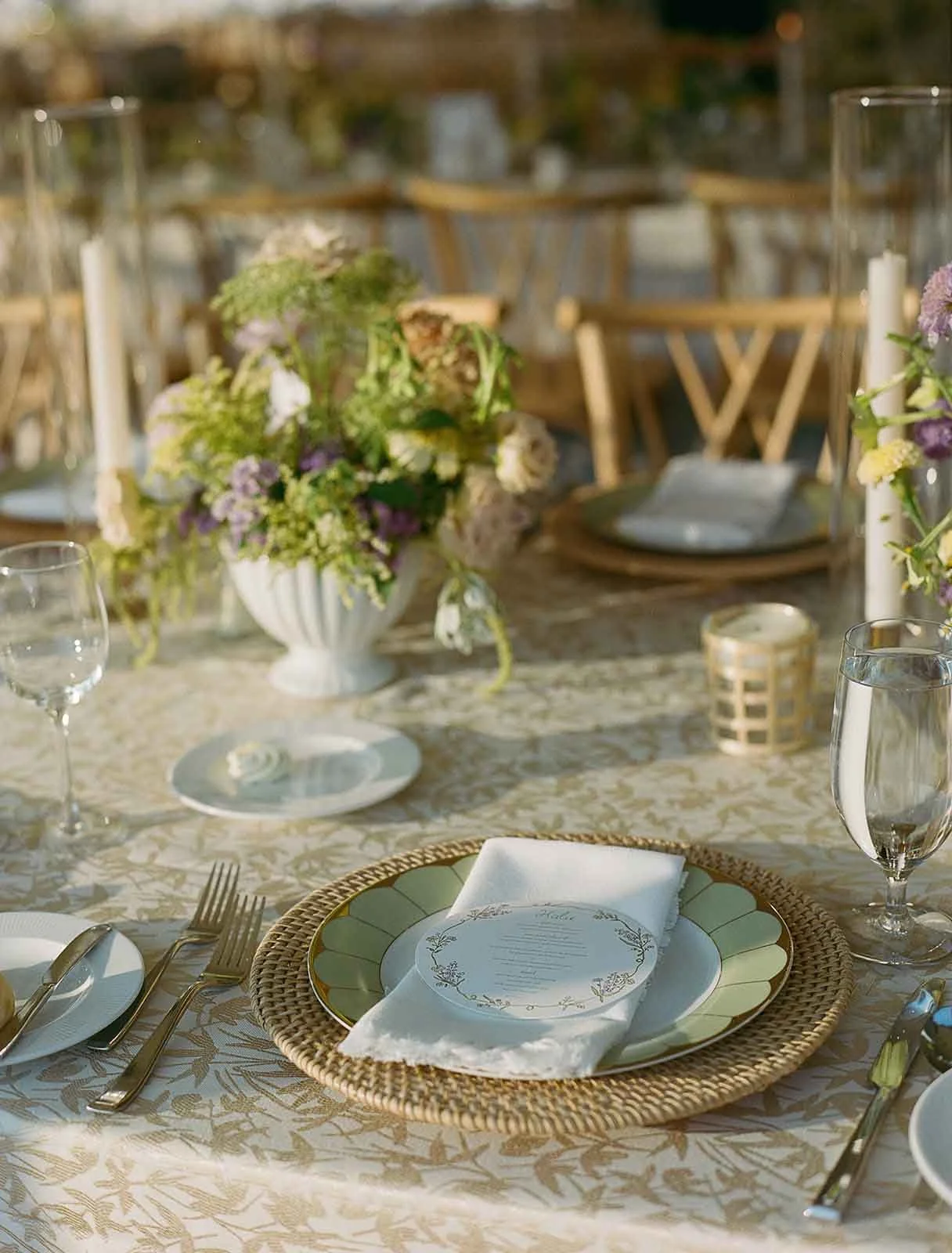 Elegant tablescape for an outdoor tent wedding in Virginia featuring florals, candles, and custom menus
