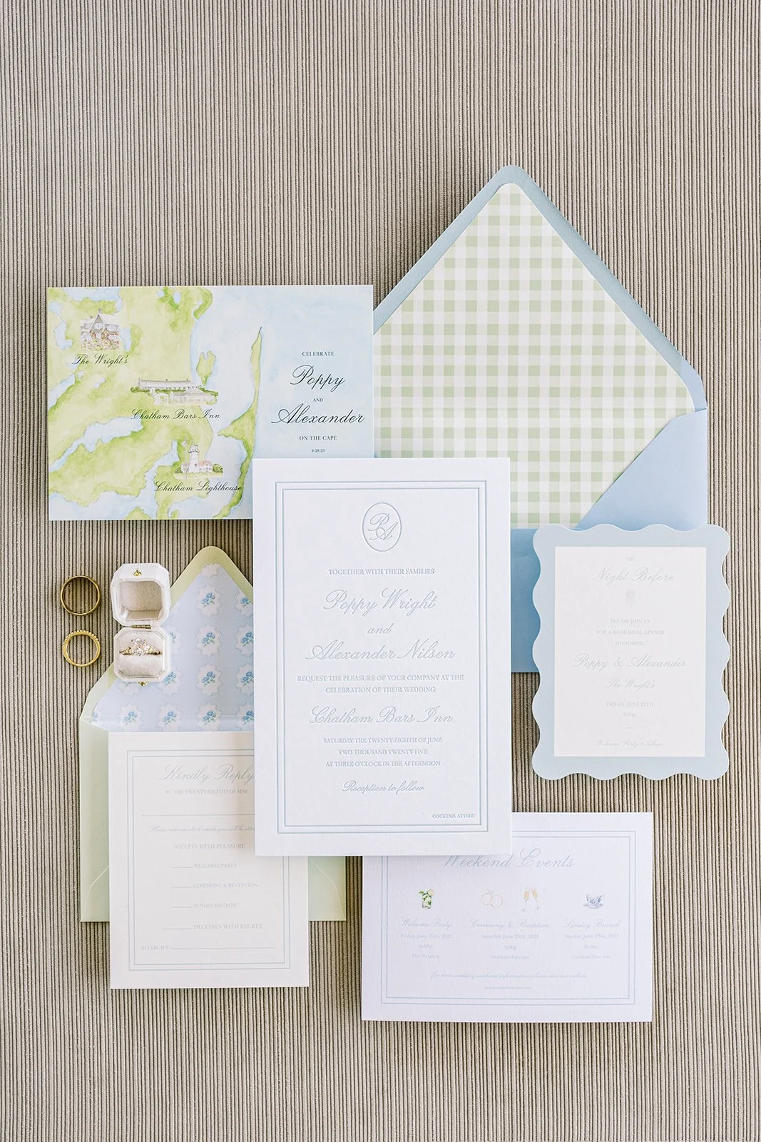 Custom coastal wedding stationery featuring a watercolor map, wedding monogram, gingham envelope liner and other wedding details on a neutral background