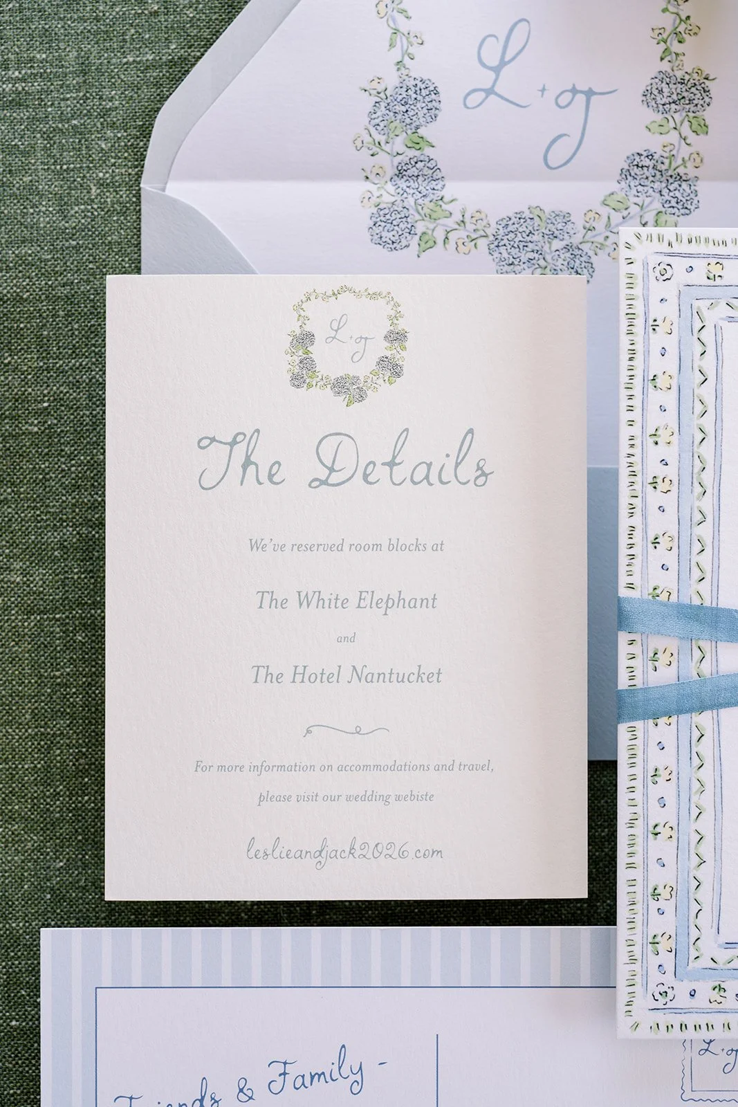 Nantucket-themed wedding stationery details featuring the details card with a monogram floral crest