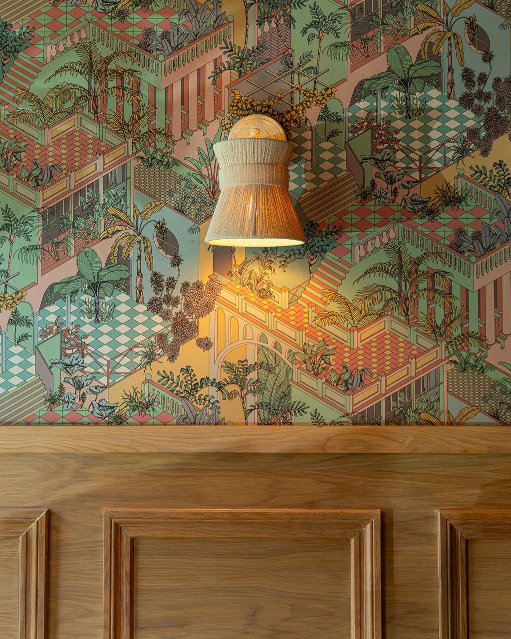 Decorative wallpaper with colorful tropical scene, a hanging lamp illuminated above a wooden surface.