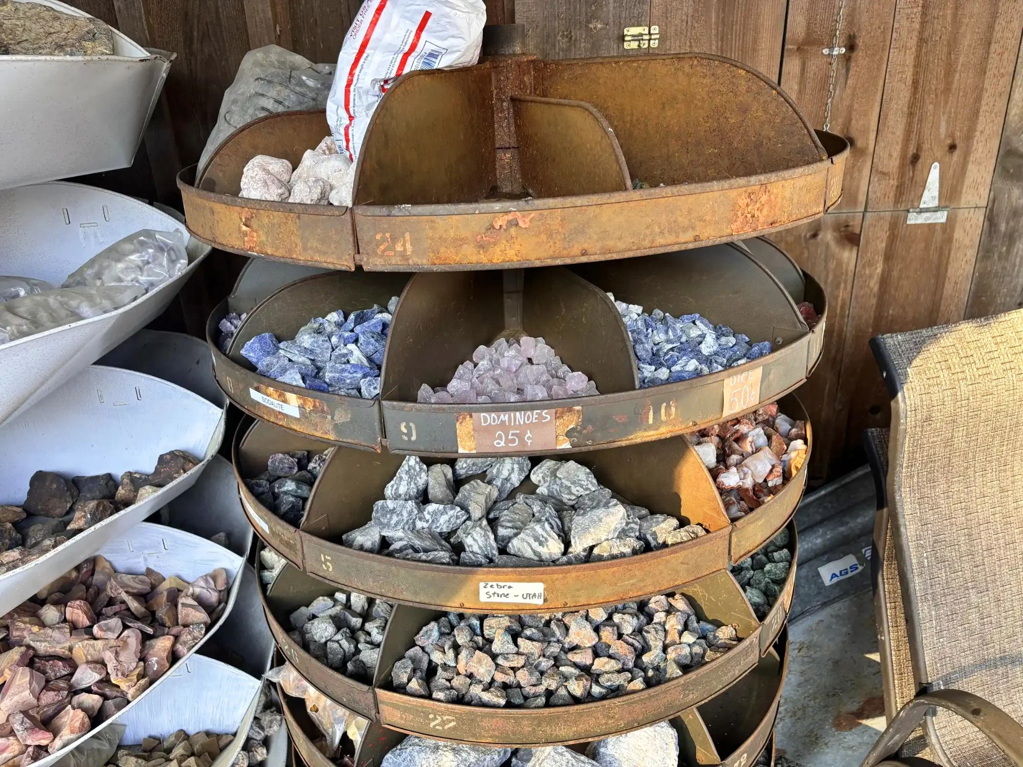 shop-exterior-outdoor-rusty-tiered-rack-sodalite-zebra-stone-utah-freds-rock-shop-putney-vt.webp