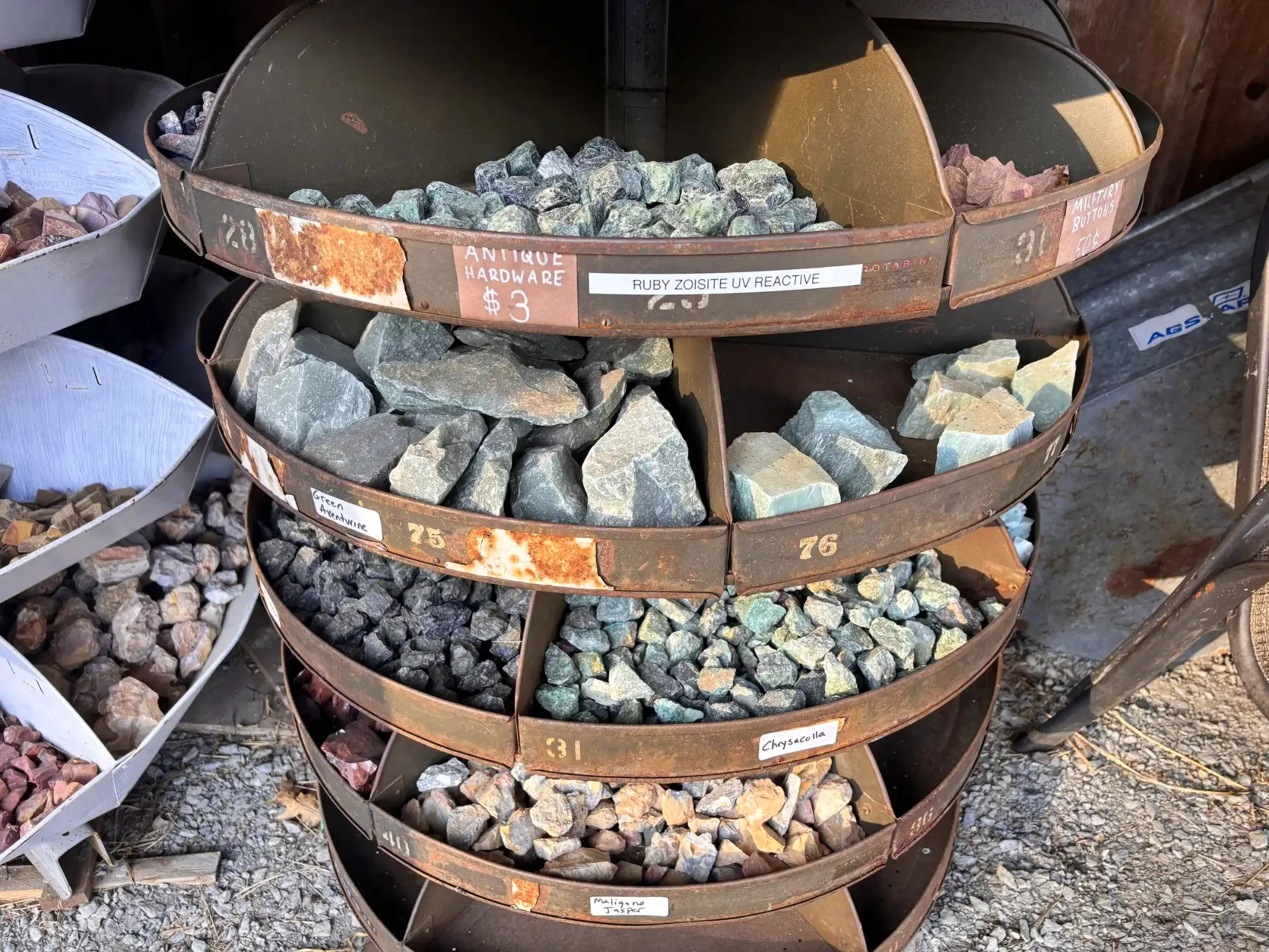 shop-exterior-outdoor-rusty-tiered-rack-ruby-zoisite-green-adventurine-chrysocolla-freds-rock-shop-putney-vt.webp