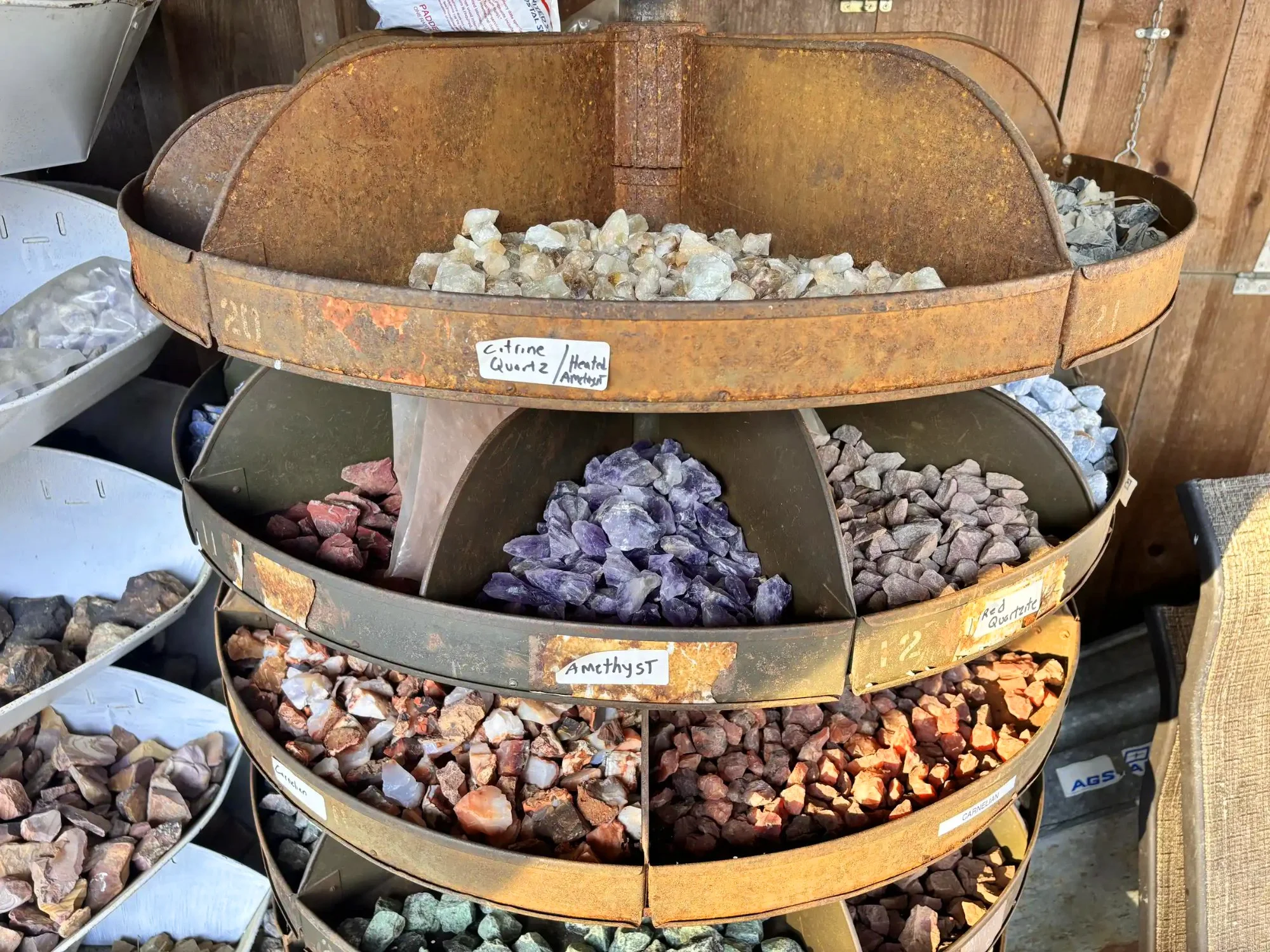 shop-exterior-outdoor-rusty-tiered-rack-citrine-amethyst-carnelian-close-up-freds-rock-shop-putney-vt.webp