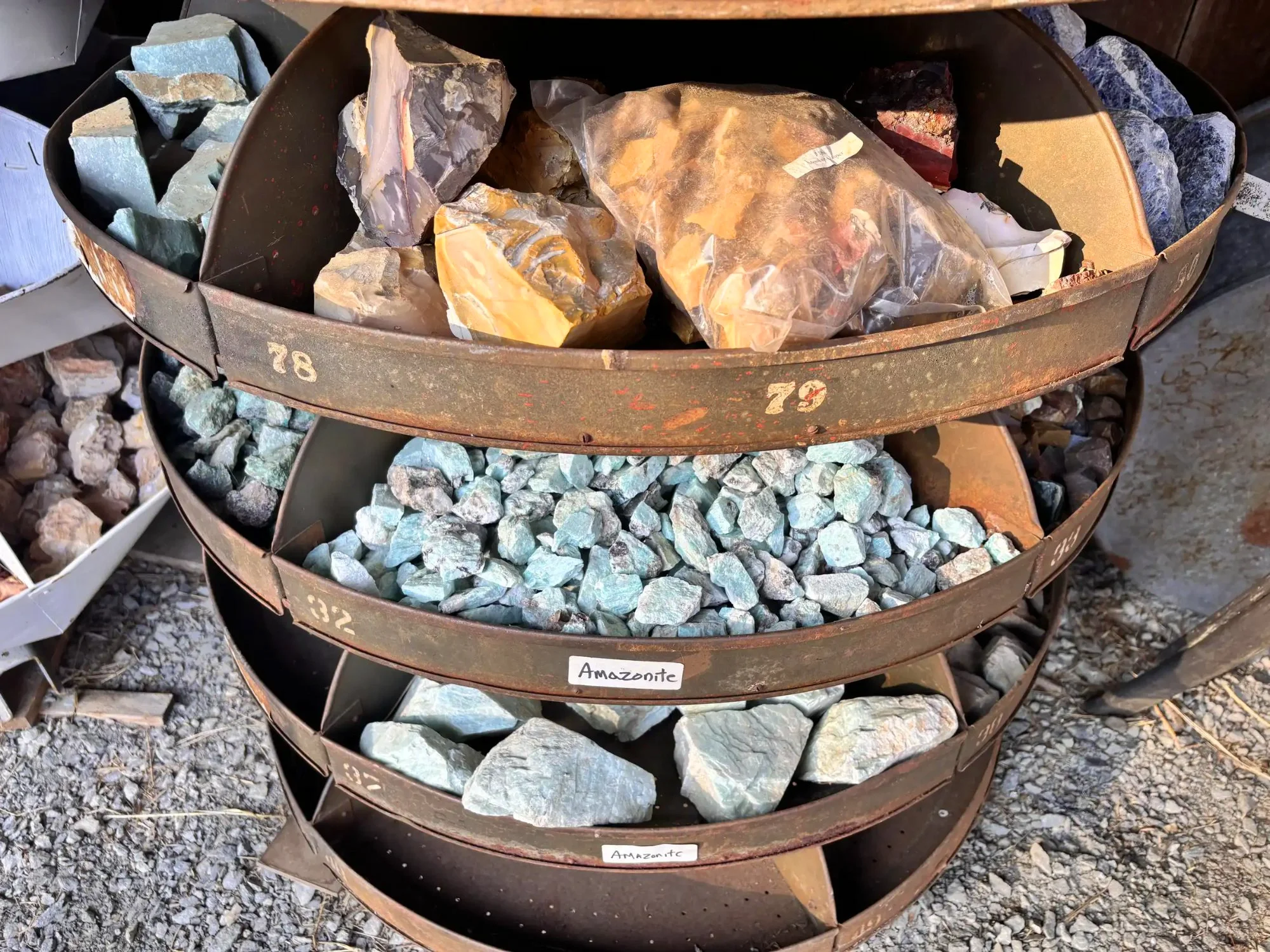 shop-exterior-outdoor-rusty-tiered-rack-amazonite-mixed-agate-lower-tiers-freds-rock-shop-putney-vt.webp