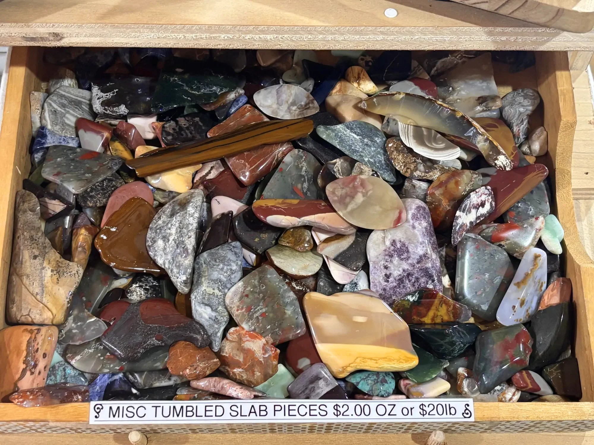 display-polished-misc-tumbled-slab-pieces-drawer-overhead-freds-rock-shop-putney-vt.webp