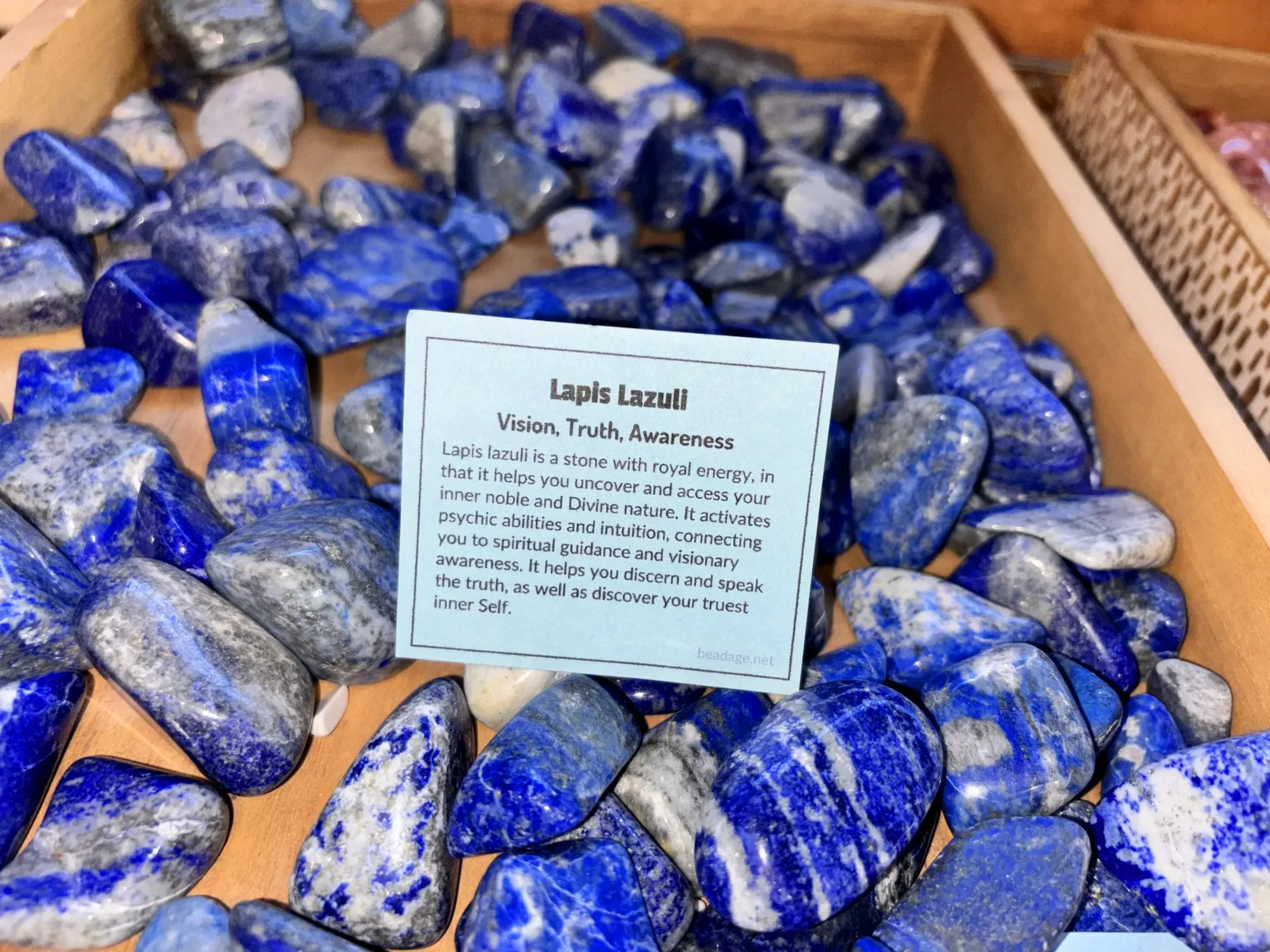 lapis-lazuli-tumbled-stones-vision-truth-awareness-close-up-freds-rock-shop-putney-vt-hero.webp