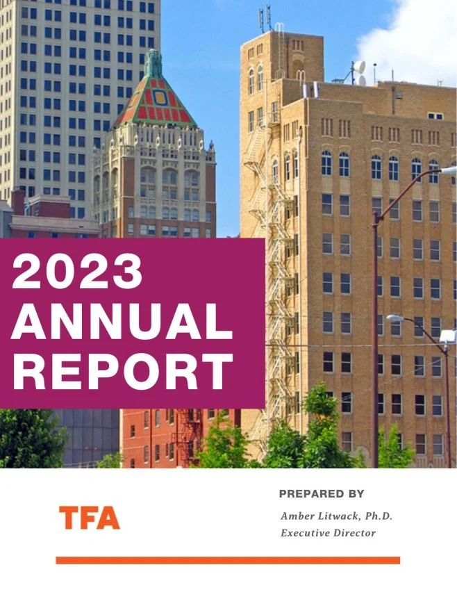 Cover of a 2023 annual report with a cityscape background featuring tall buildings and a prominent historic building with a colorful roof, and the title '2023 Annual Report' in large white letters on a purple background.