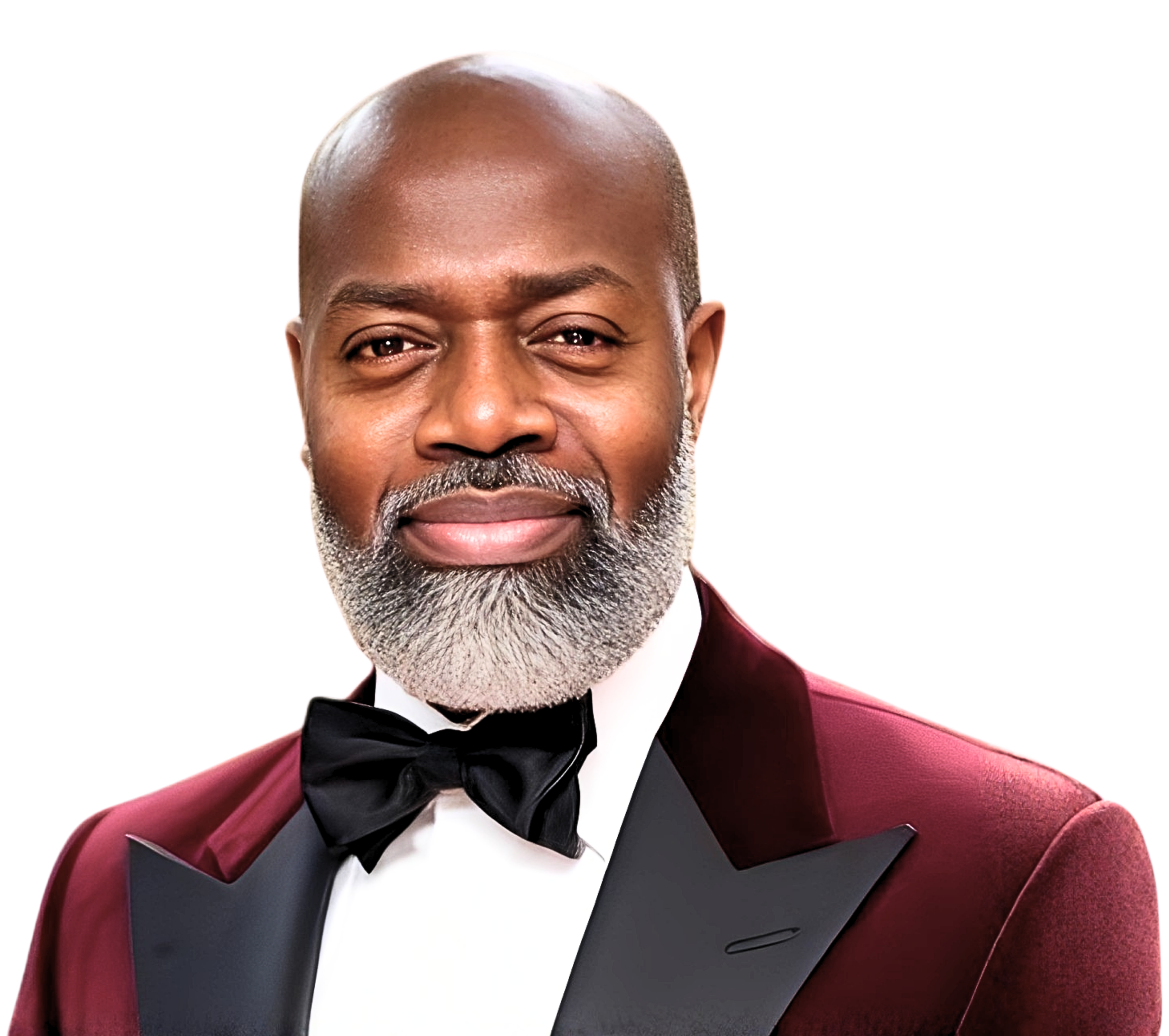 A bald African American man with a gray beard smiling, dressed in a burgundy tuxedo with a black lapel, white shirt, and black bow tie.