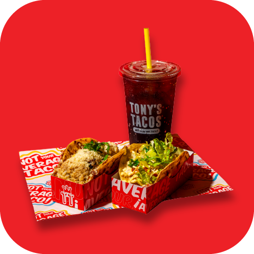 A plate with two tacos topped with sauce, shredded cheese, and vegetables, a bowl of guacamole, tortilla chips, a plate of beef and vegetables with sauce, and a glass of Coca-Cola on a red background.