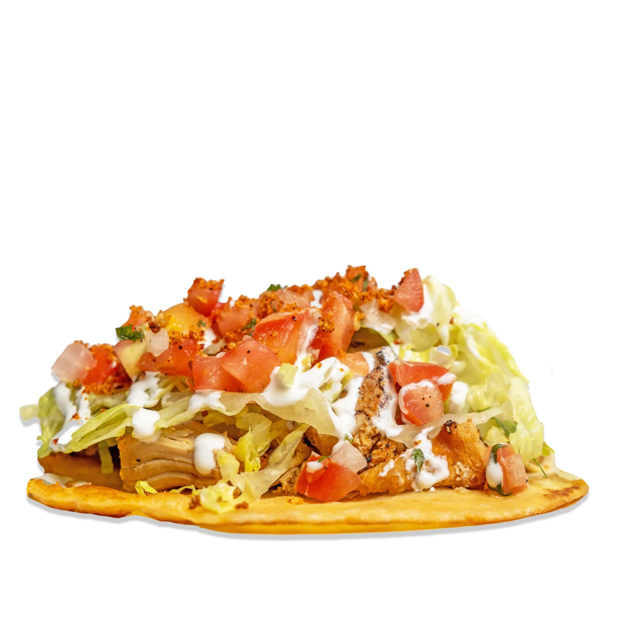 Close-up of a taco with lettuce, diced tomatoes, sour cream, and shredded chicken on a crispy shell.
