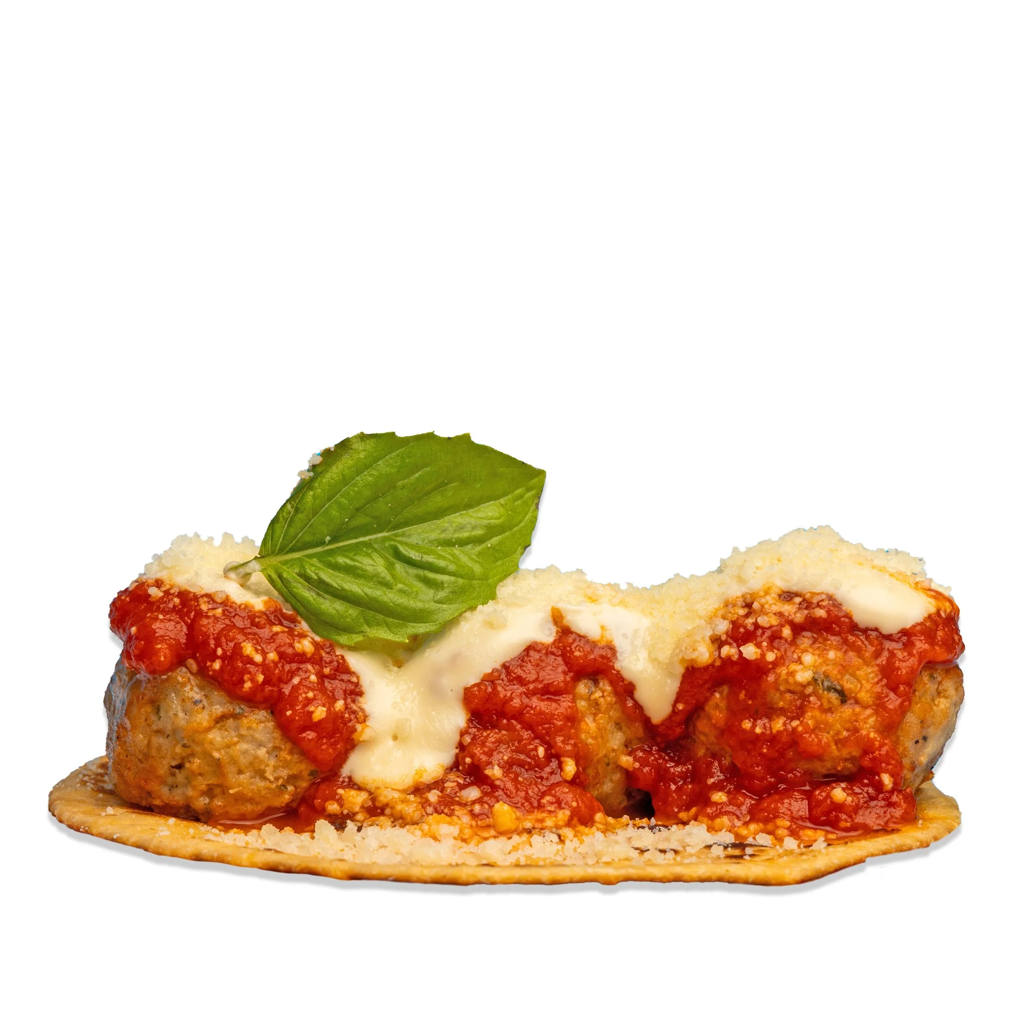 Slice of pizza topped with meatballs, marinara sauce, melted cheese, and a basil leaf.
