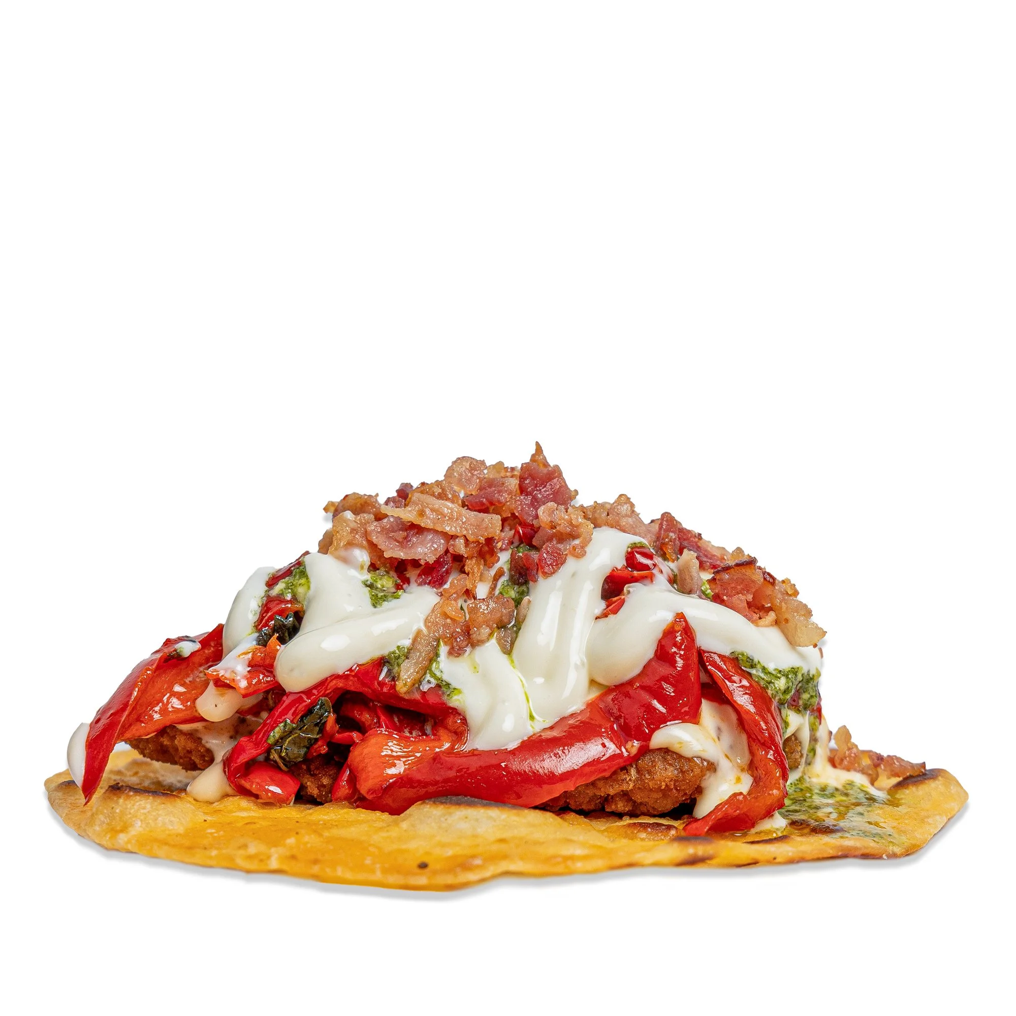 A serving of chicken and red pepper on a crispy flatbread crust, topped with melted cheese, bacon bits, and garnished with herbs.