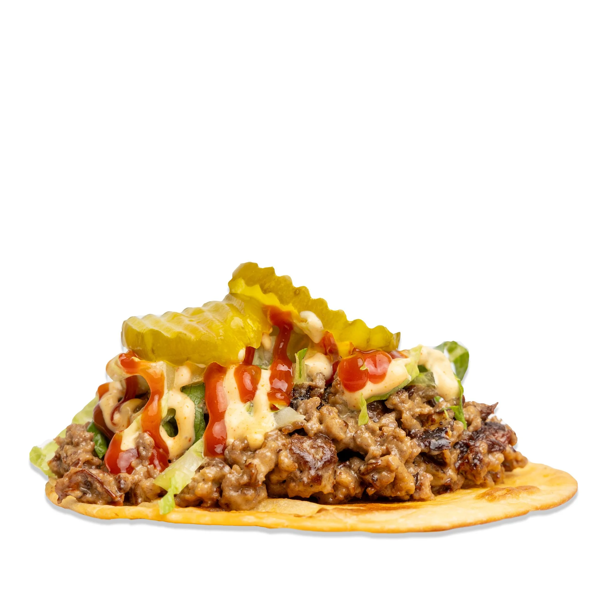 Taco with seasoned ground beef, lettuce, pickles, mayonnaise, ketchup, and mustard on a soft tortilla.