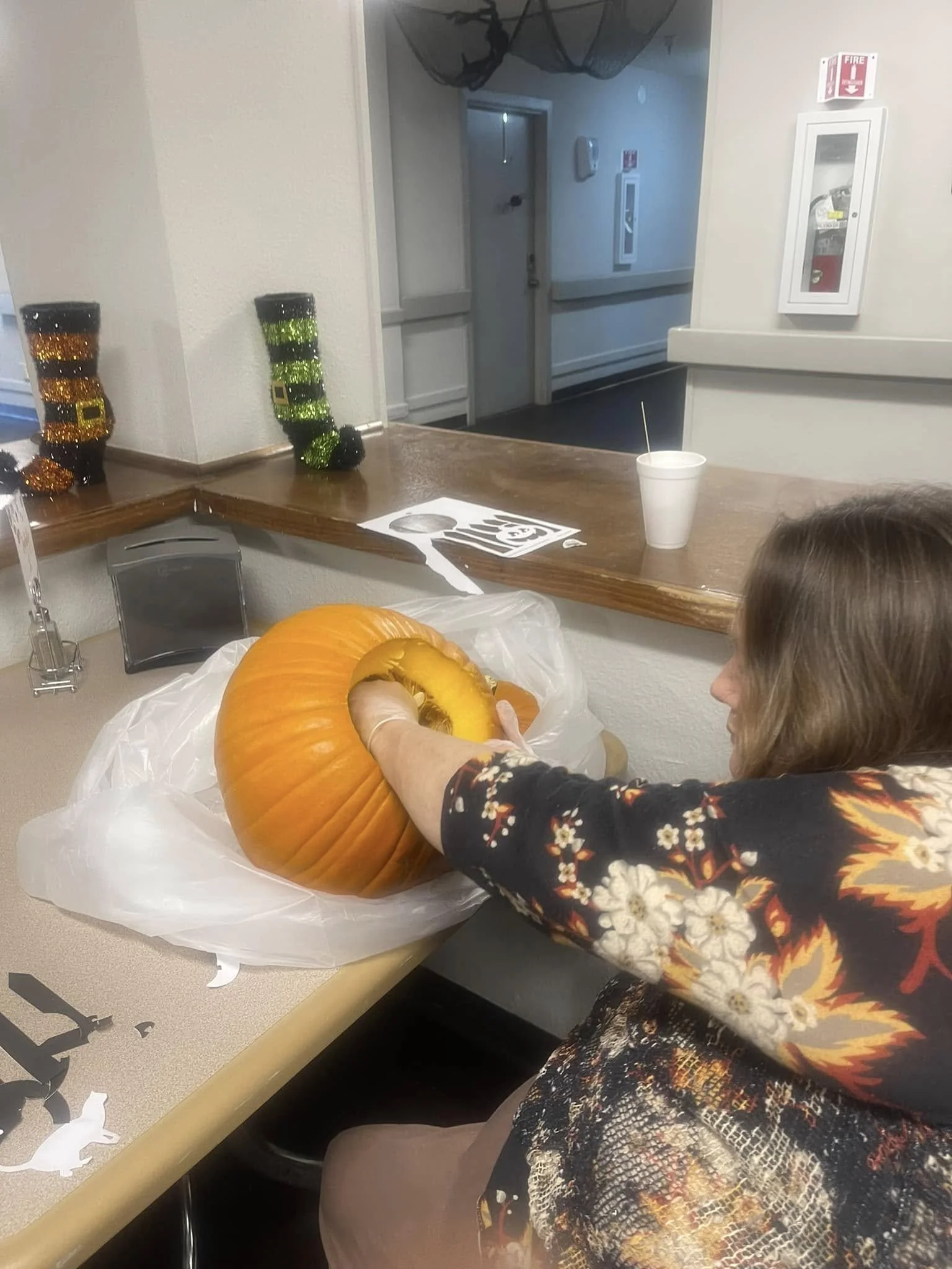 Resident carving a pumpkin