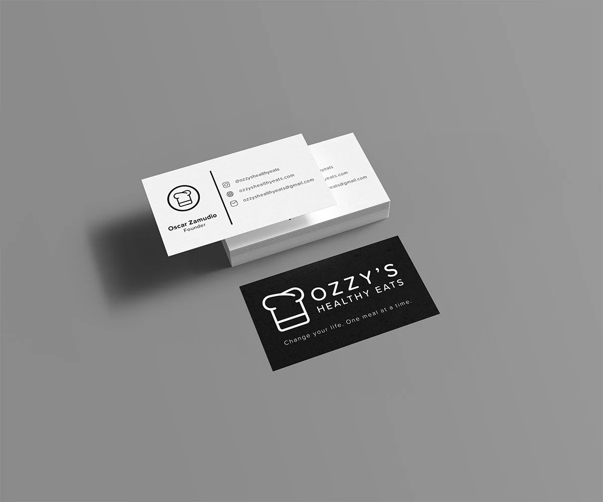 Stack of business cards displaying the logo of the business against a gray background.