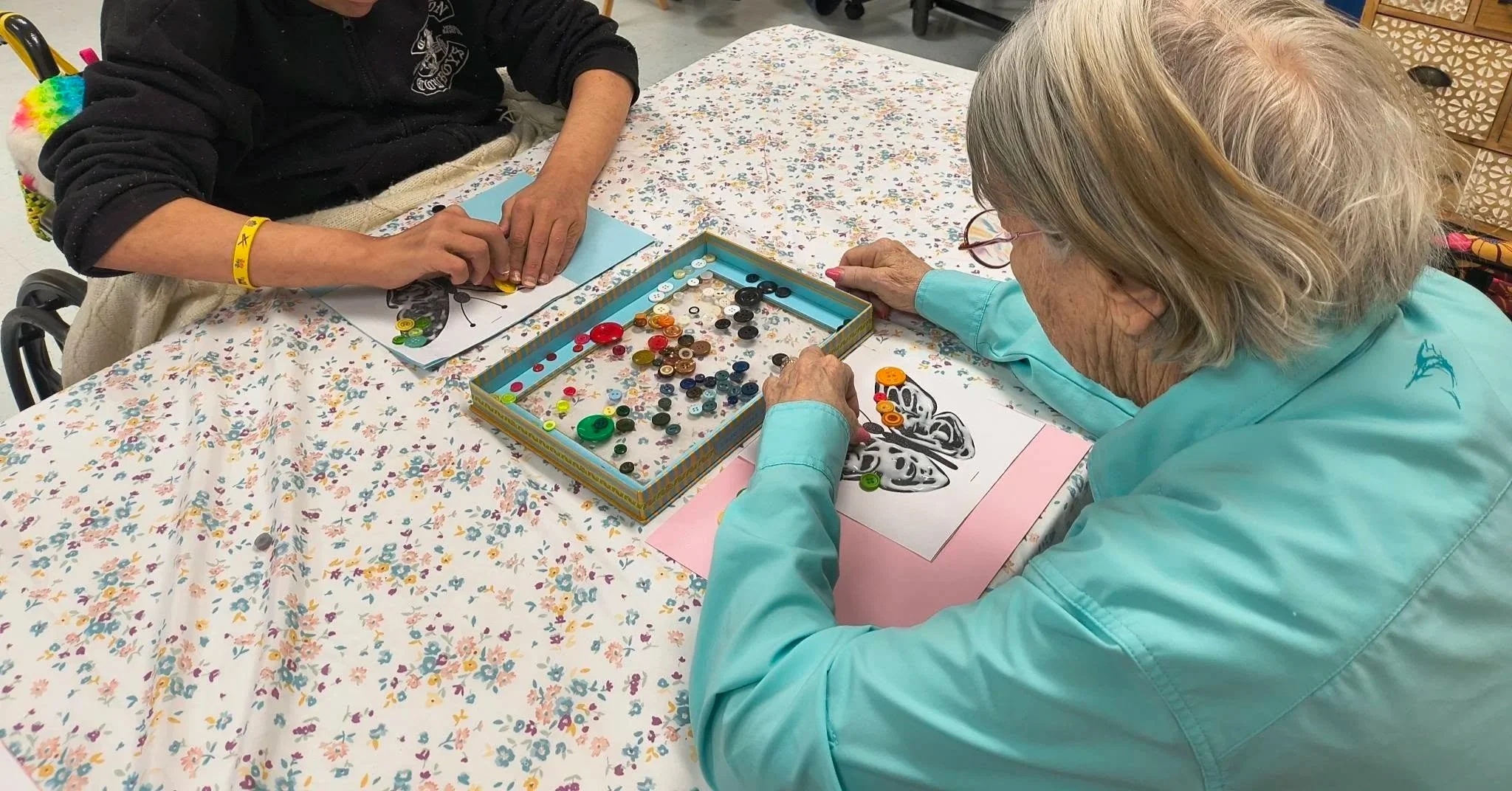 Two people making butterly art