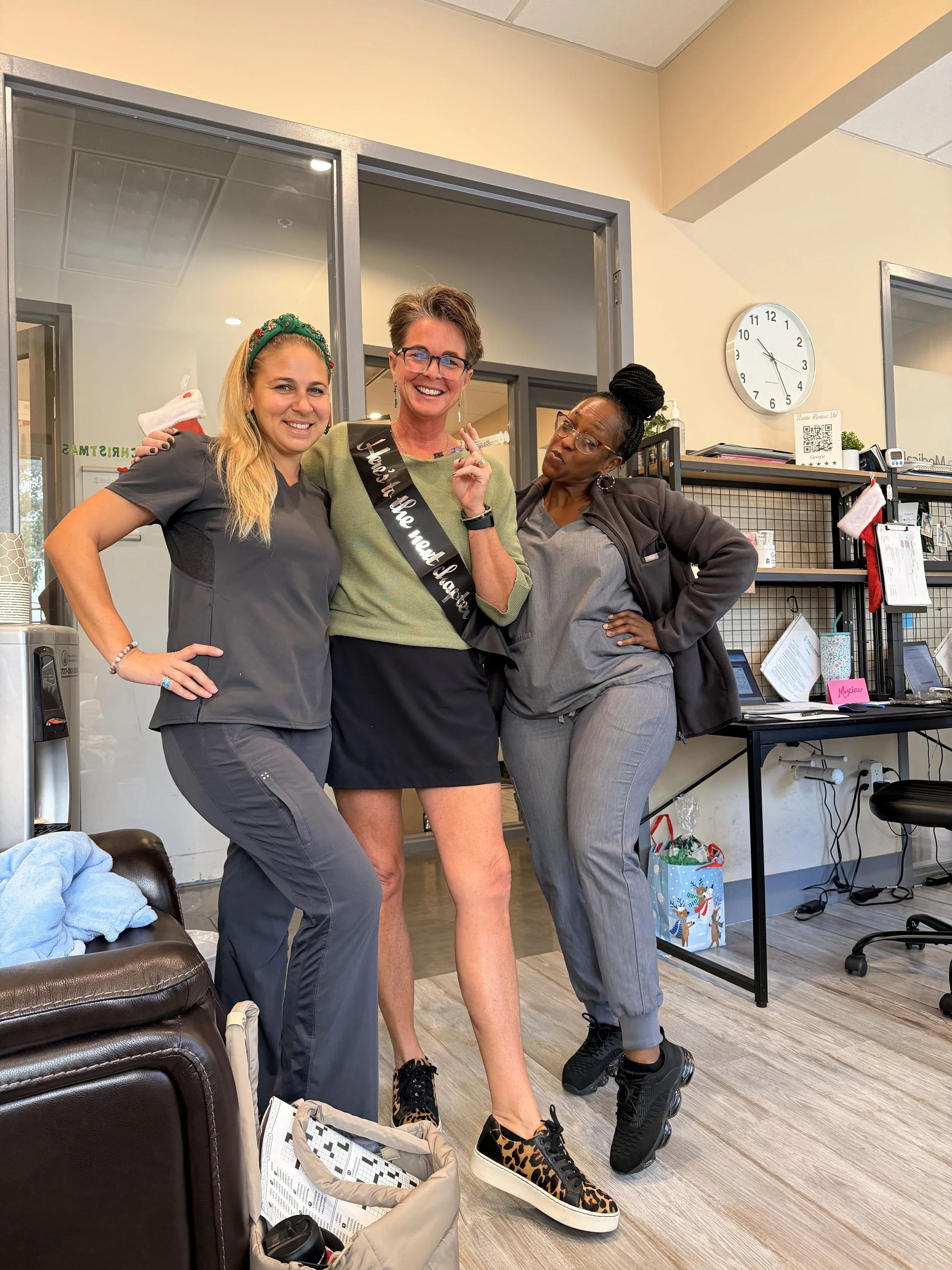Carlee, Gail Billman and another nurse standing together in the lobby of a functional medicine office in Clearwater Florida.