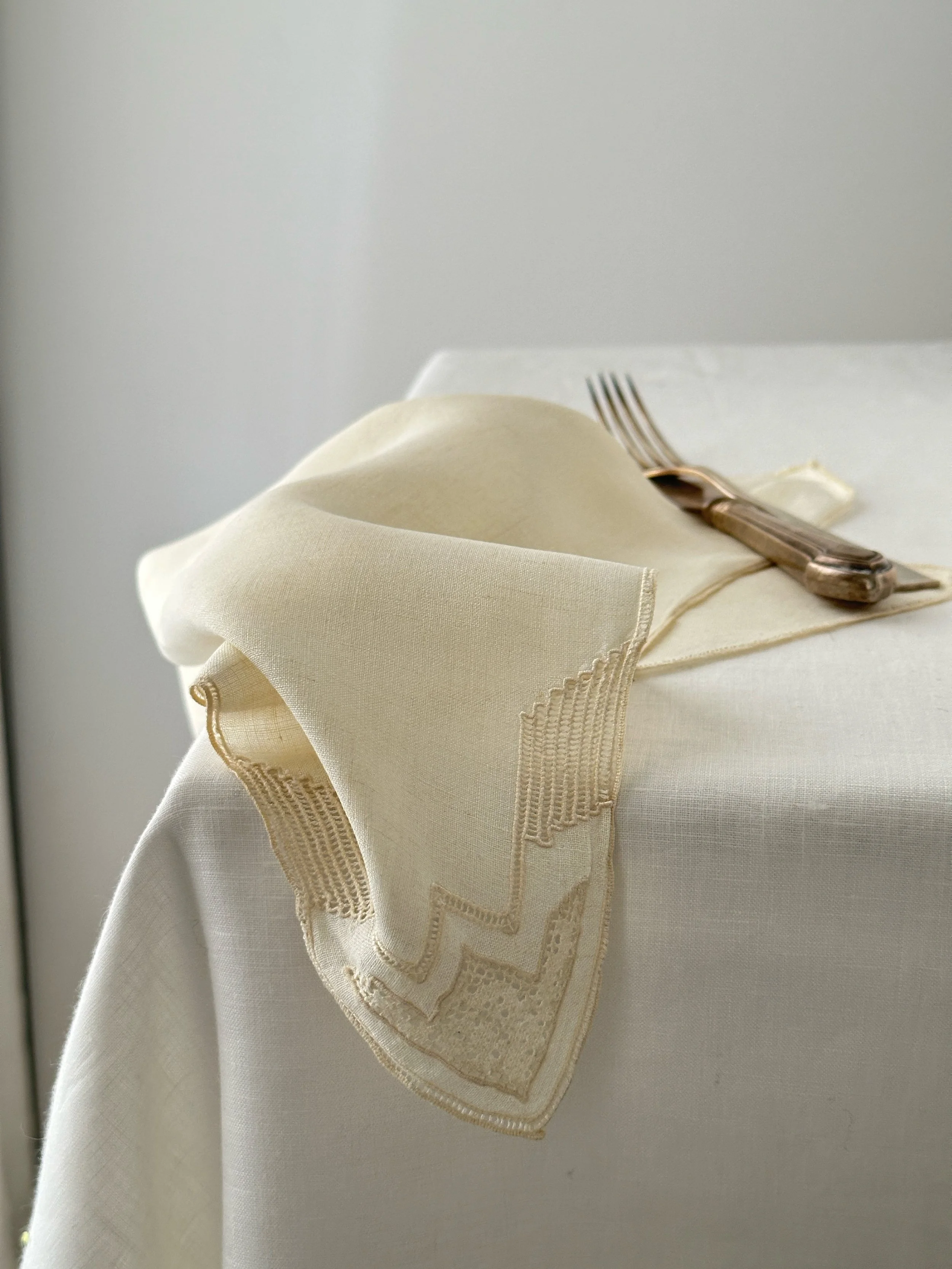 Fine handkerchief linen napkin in vintage ivory with lace edge
