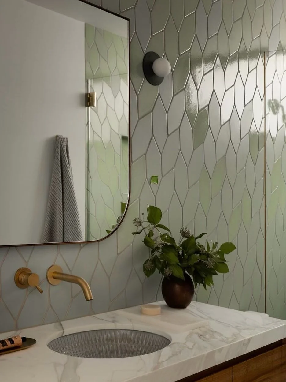 The leaf-like tile wall from @fireclaytile gives this bathroom depth and softness with varying matte and glossy finishes in a soothing green hue. 🌱

#bathroomdecor #bathroomdesign #bathroominspiration #fireclaytile #bathroomtiles